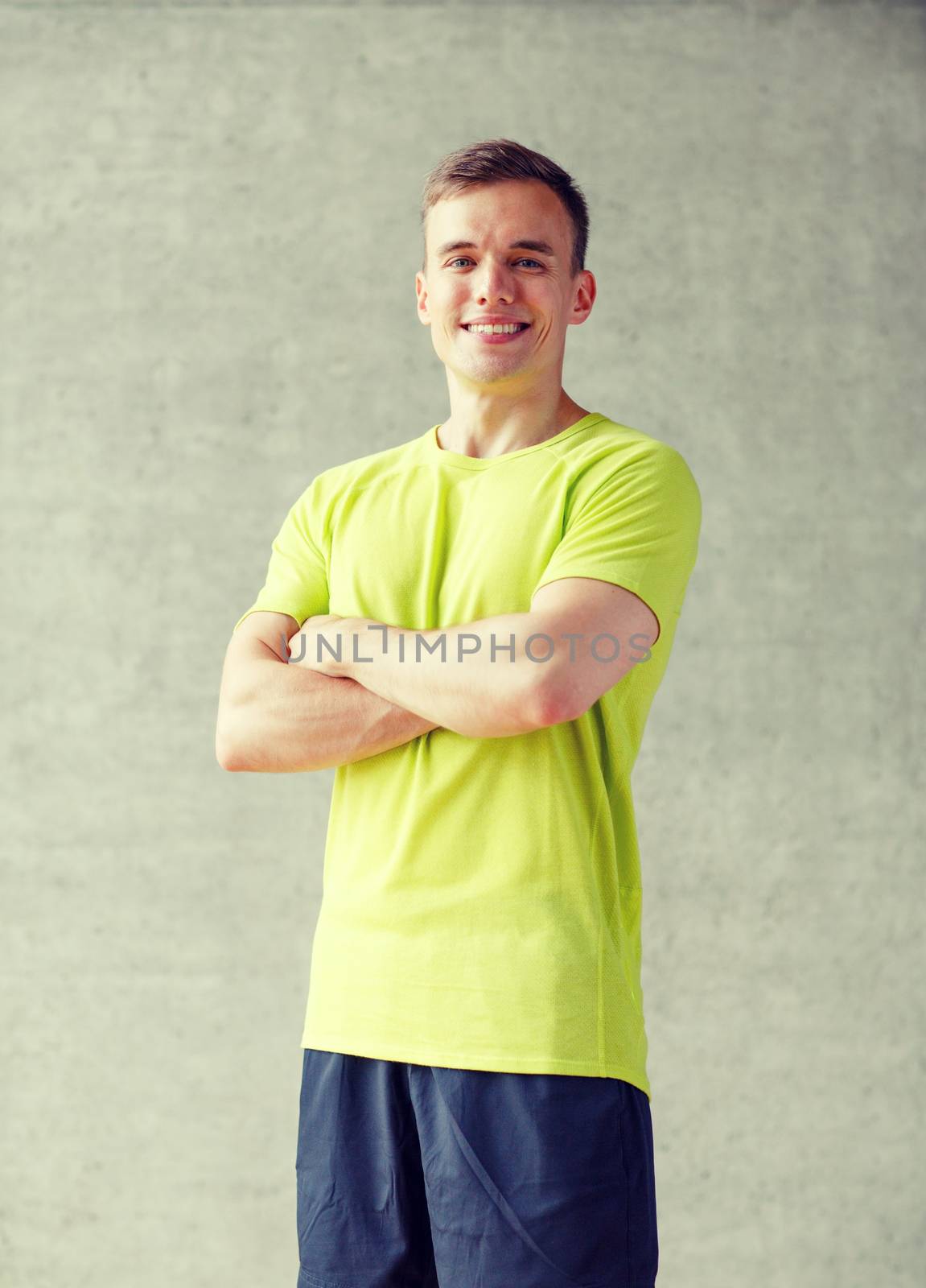 sport, fitness, lifestyle and people concept - smiling man in gym