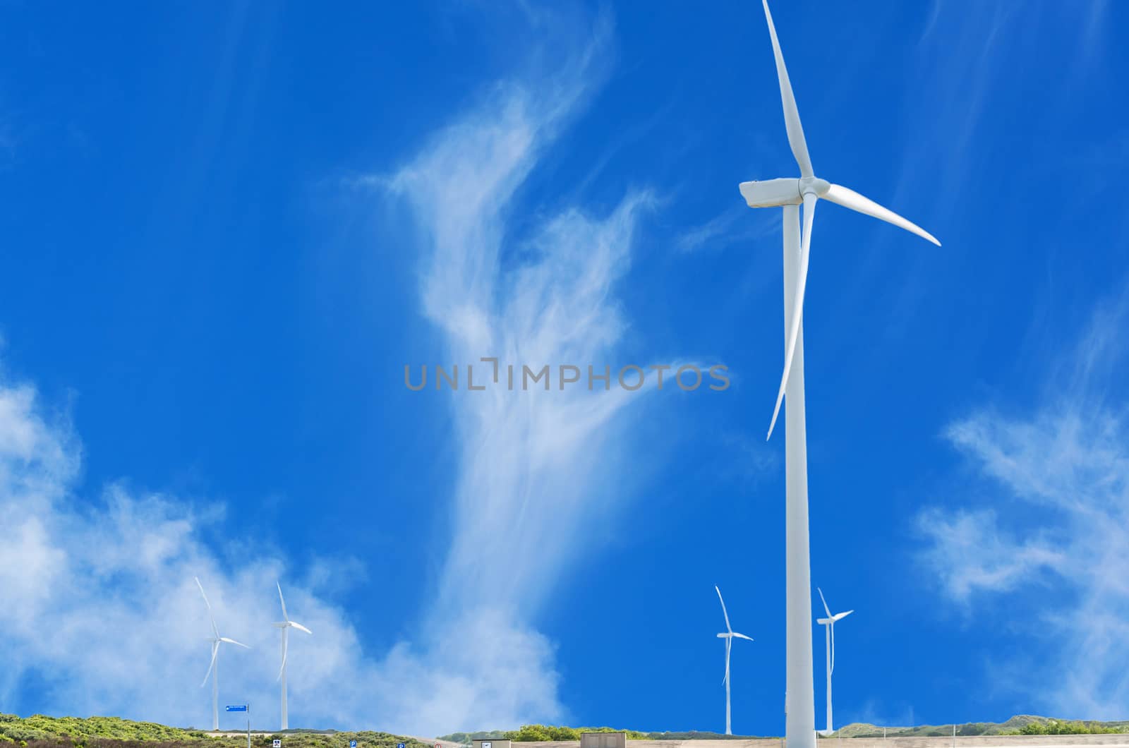 Wind Turbine on the Dutch North Sea coast with blue sky.
