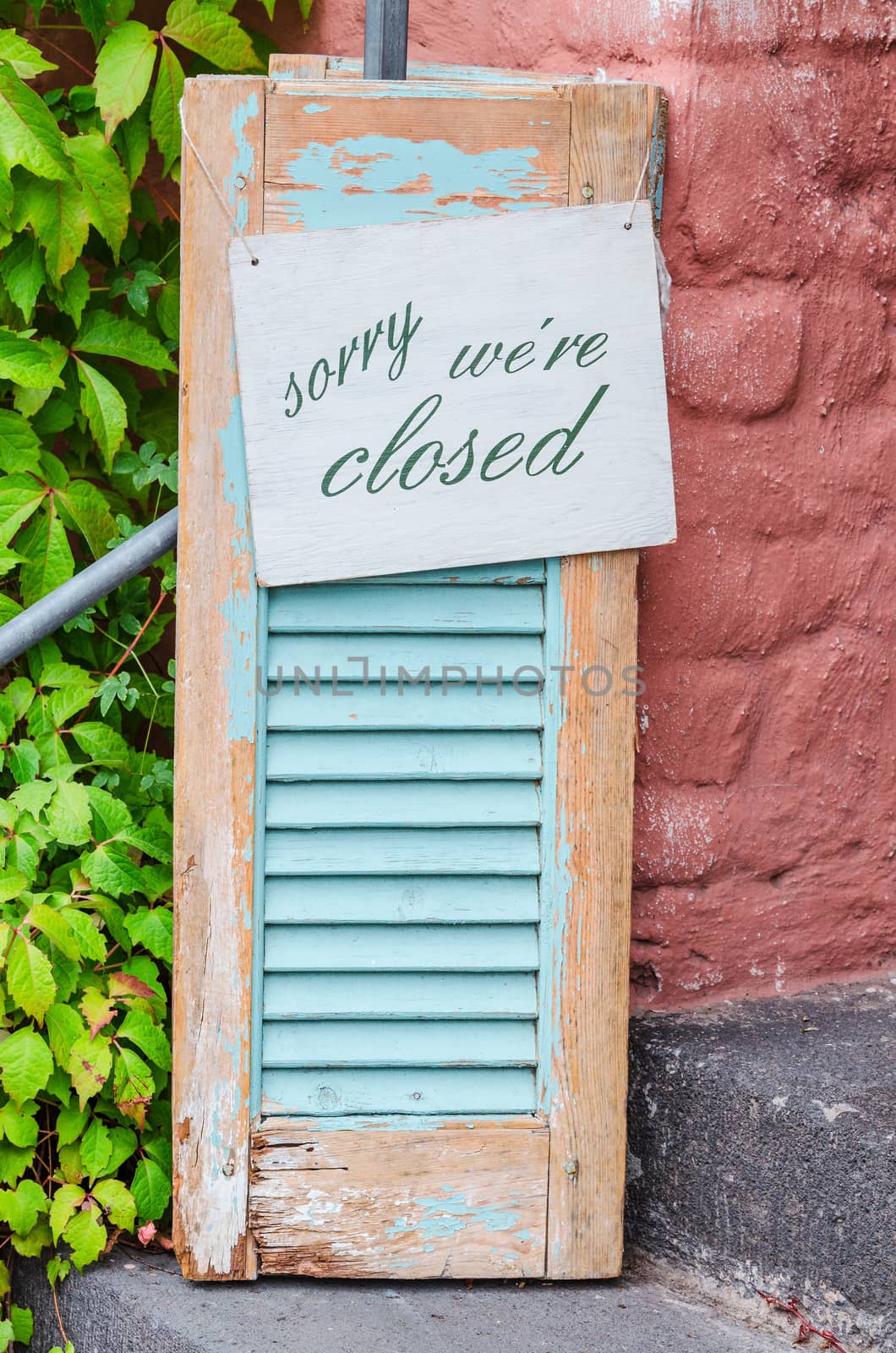 Age decorative weathered wooden shutters with information sign