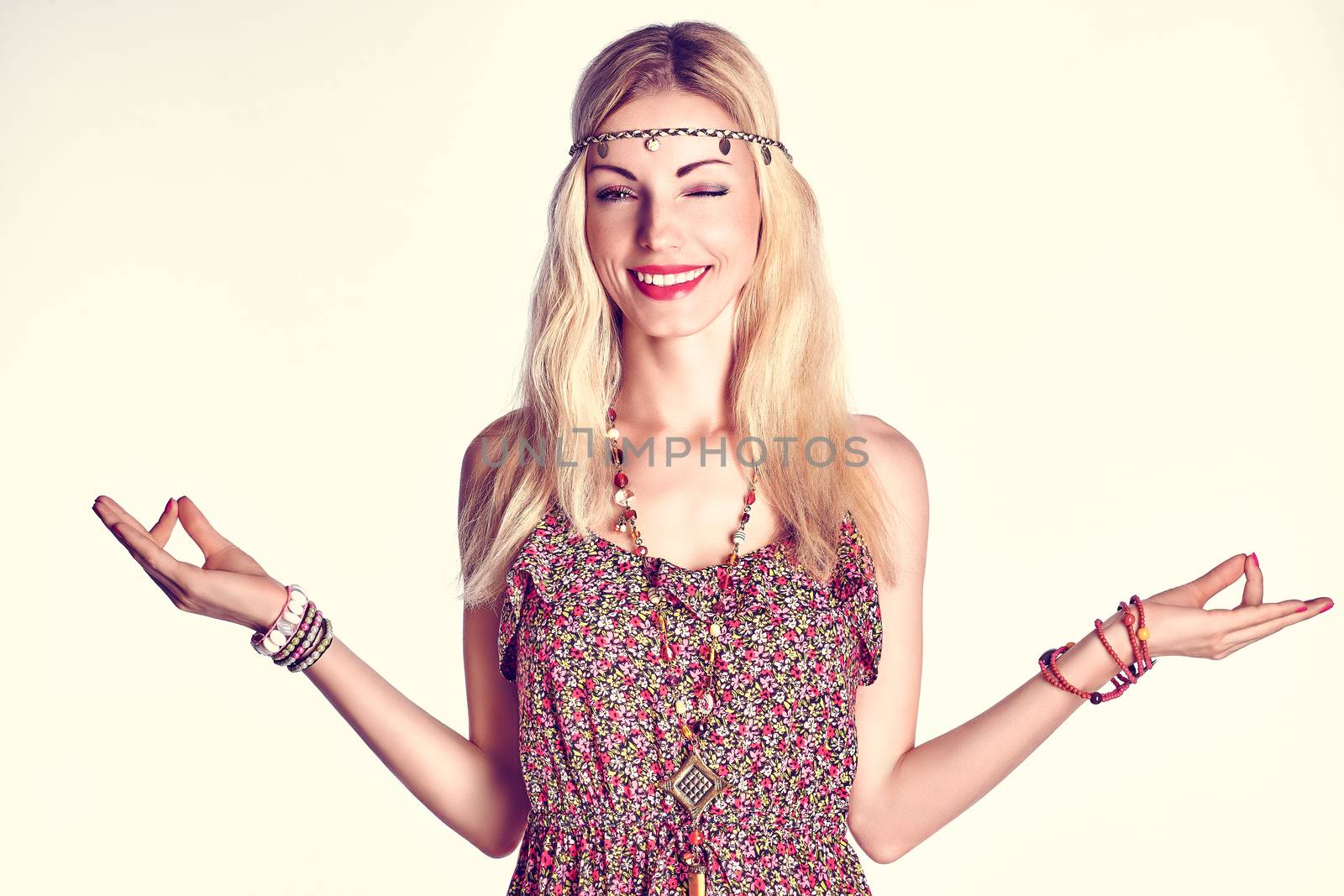 Beauty portrait of boho woman happy winking, smiling, doing yoga, people, copyspace. Hippie model girl meditates, enjoying relax, harmony. Unusual joyful positive blonde woman in floral sundress, fun