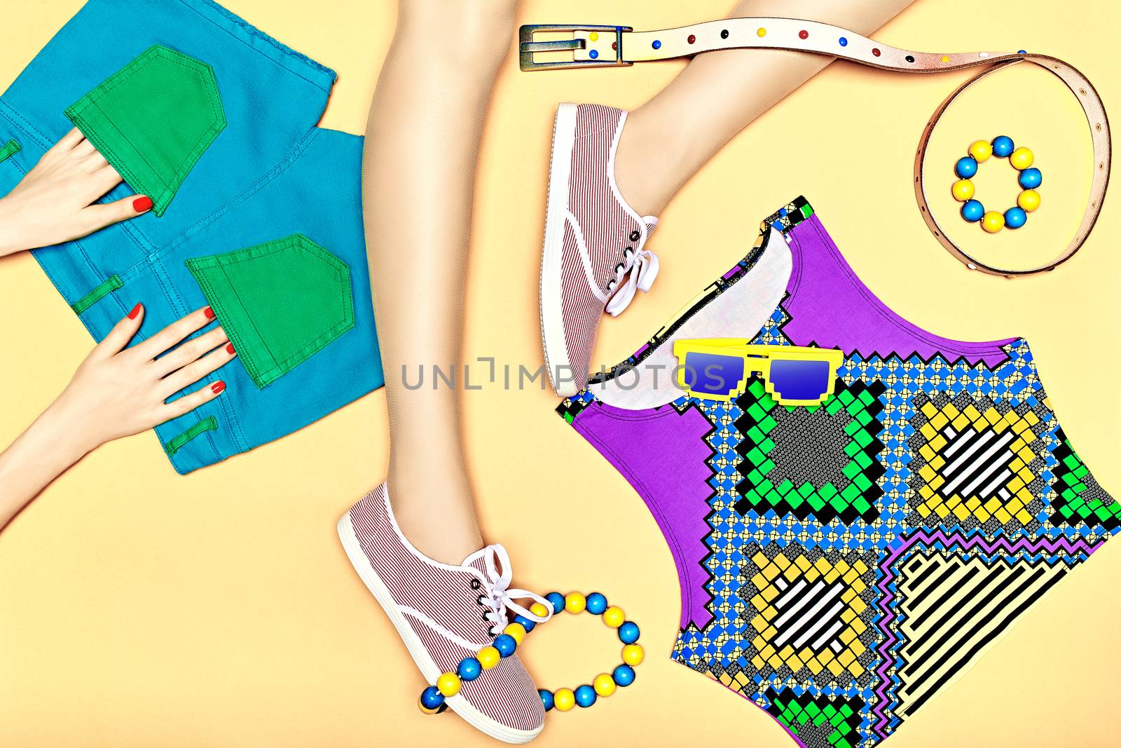 Fashion clothes stylish set, accessories, womans sexy legs, hands, people. Hipster girl creative look in trendy gumshoes, top, shorts, sunglasses, belt. Unusual vivid youth style on yellow, copyspace