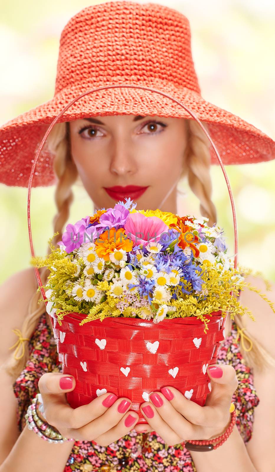 Woman on summer meadow with basket of wildflowers by 918