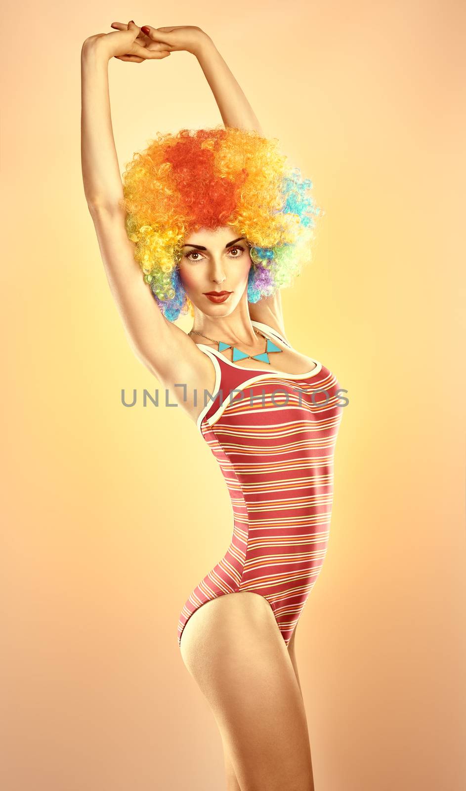 Fashion sexy beauty model slim woman in swimsuit sensually looks, vivid unusual creative people. Provocative attractive girl with trendy necklace on peach, toned. Multicolored afro hairstyle, makeup
