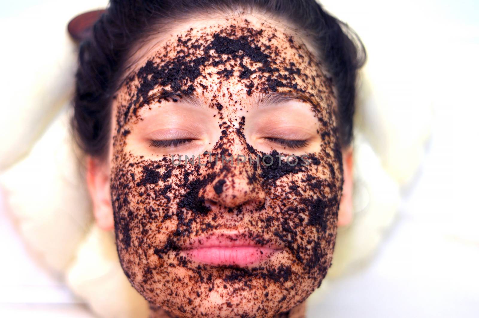 portrait of a girl with eyes closed in a cosmetic mask of coffee