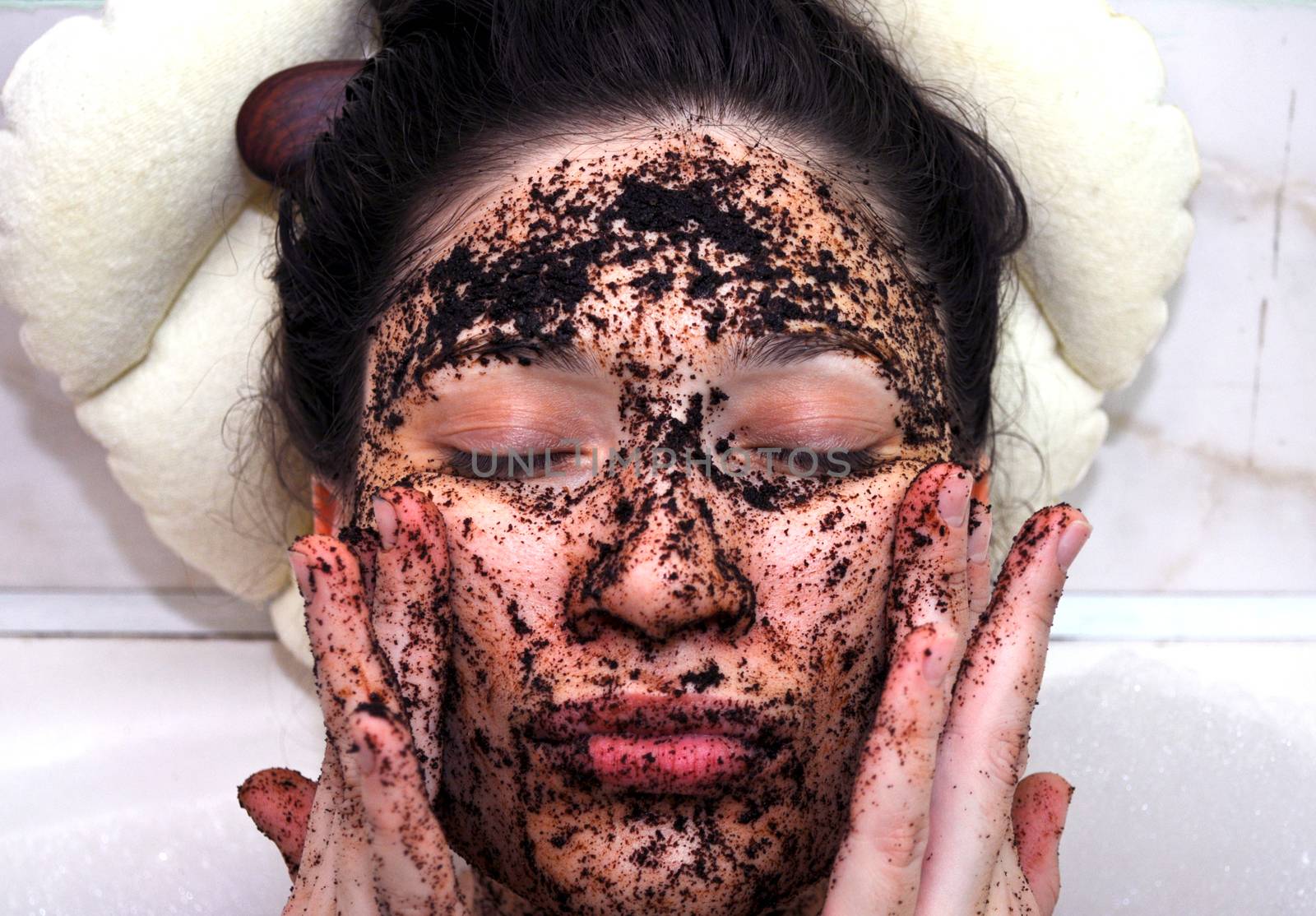 portrait of a girl with eyes closed in a cosmetic mask of coffee