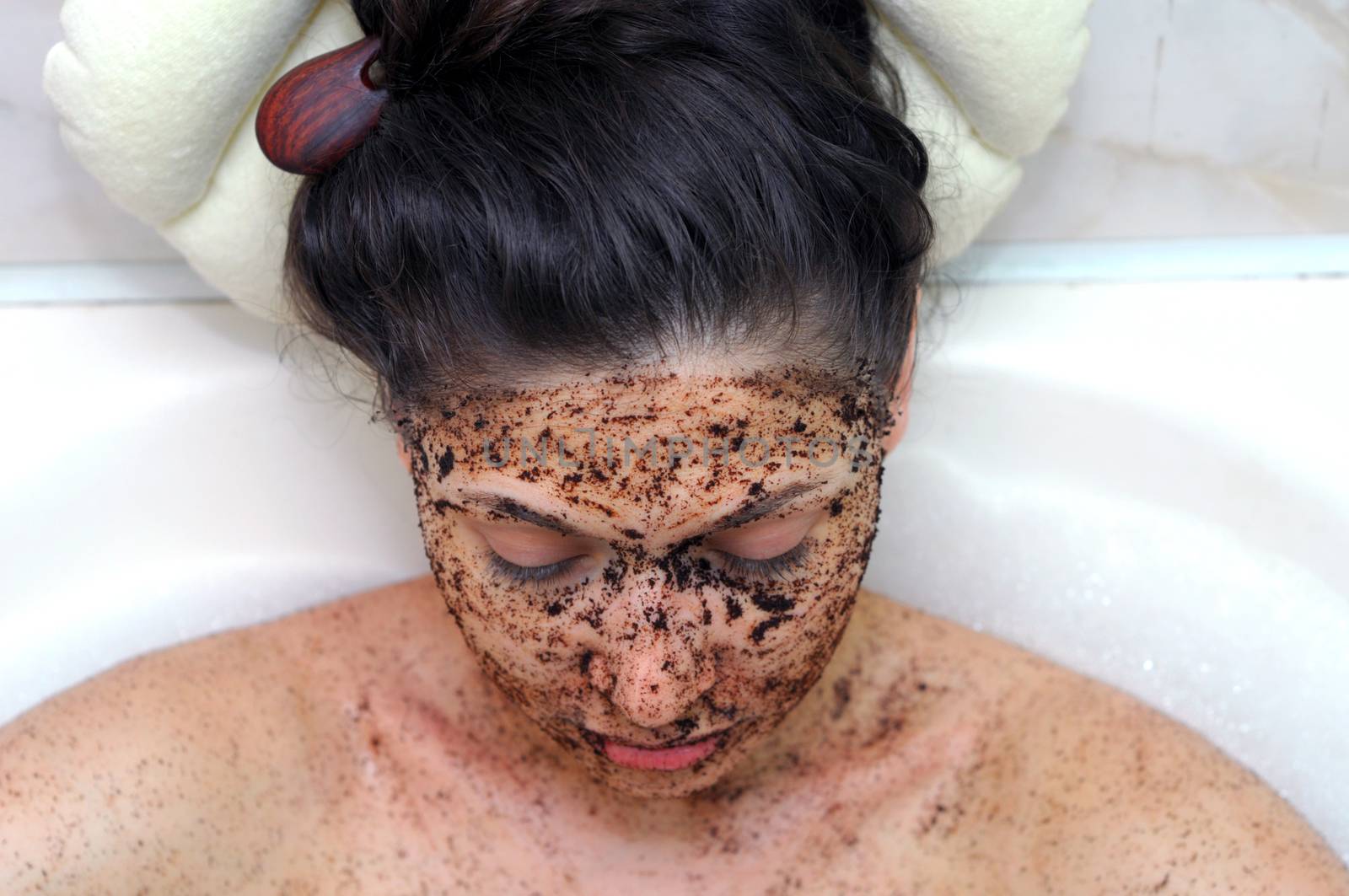 portrait of a girl with eyes closed in a cosmetic mask of coffee