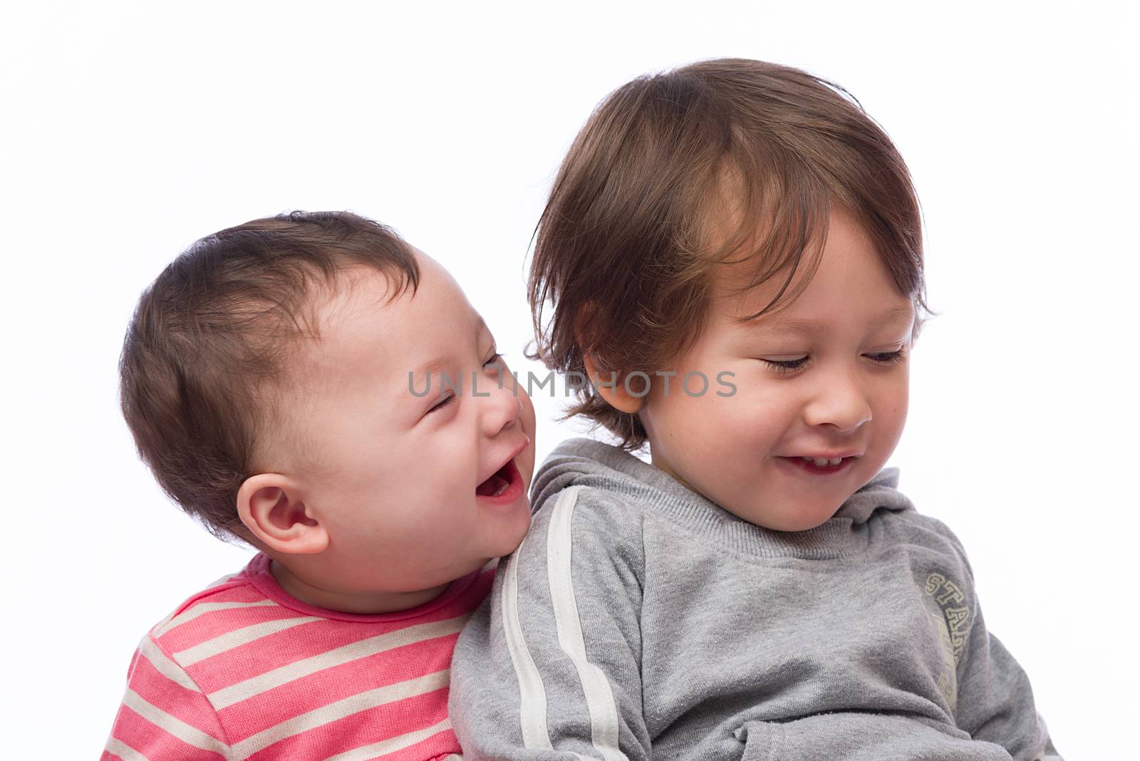 A portrait of a cute and loving brother and sister on a white background.