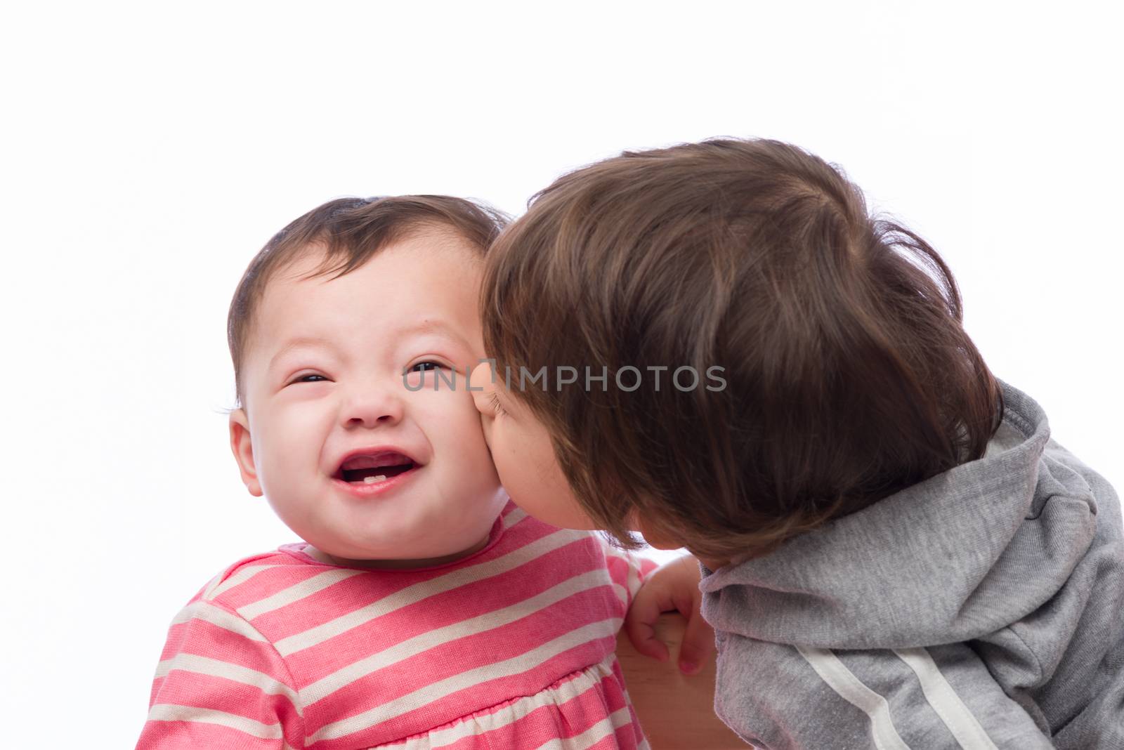 A portrait of a cute and loving brother and sister on a white background.