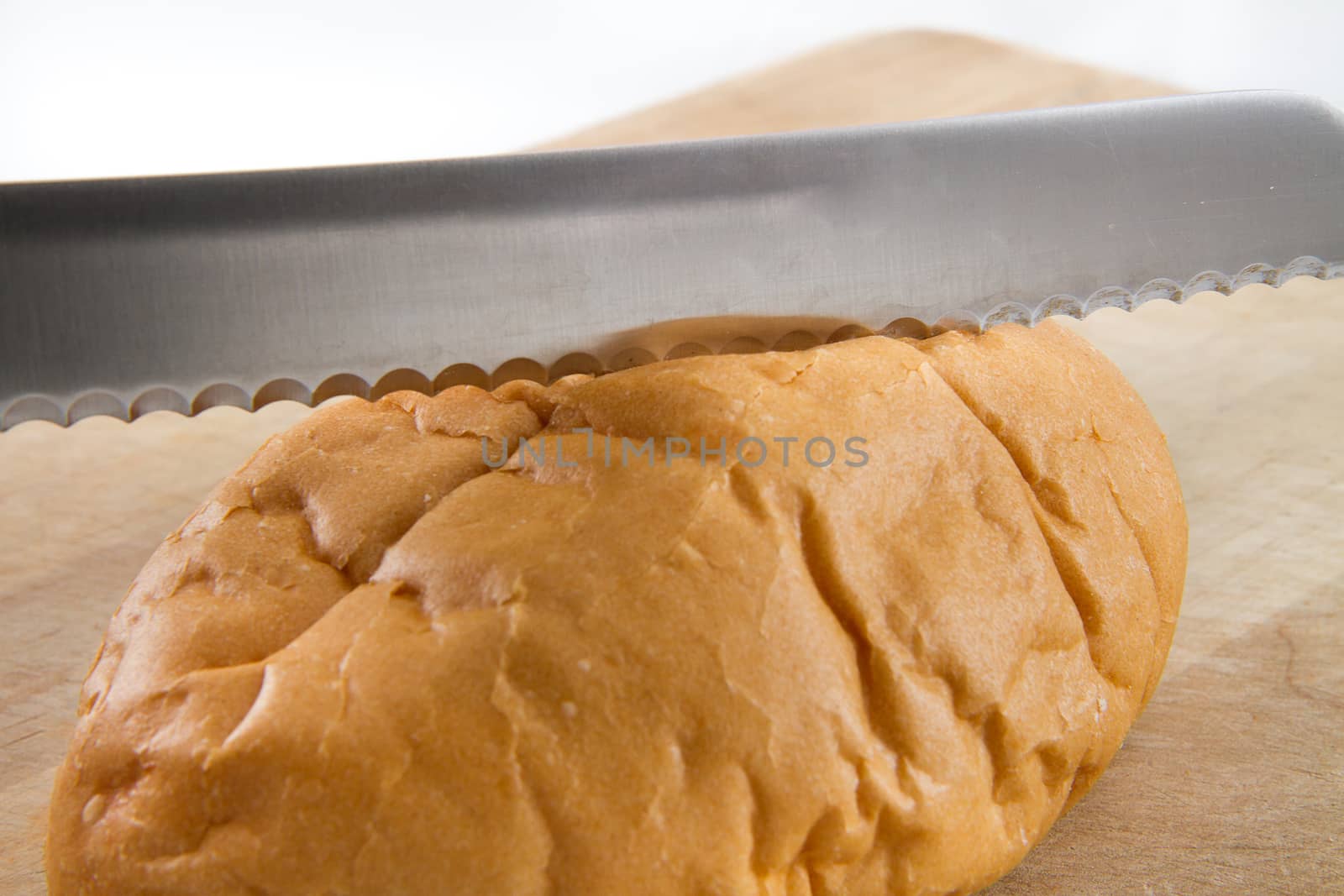 nice sharp bread knife slicing a loaf of fresh bread