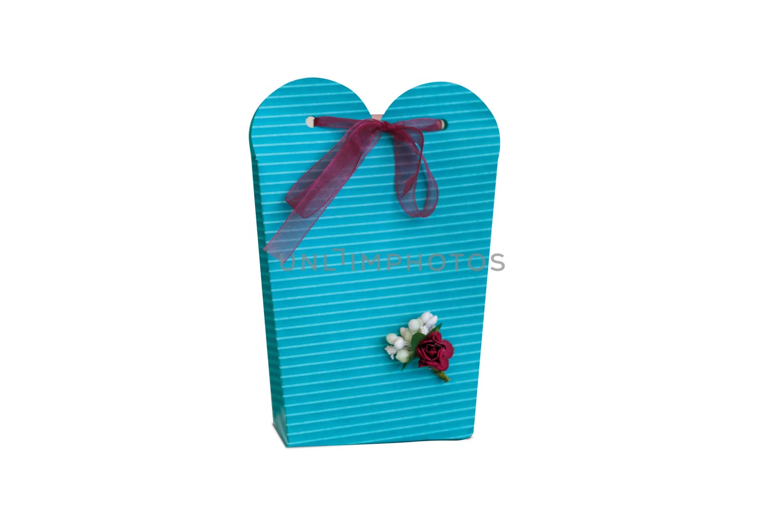 Close up detailed front view of hand-crafted green gift box with small flowers and colorful ribbons, isolated on white background.