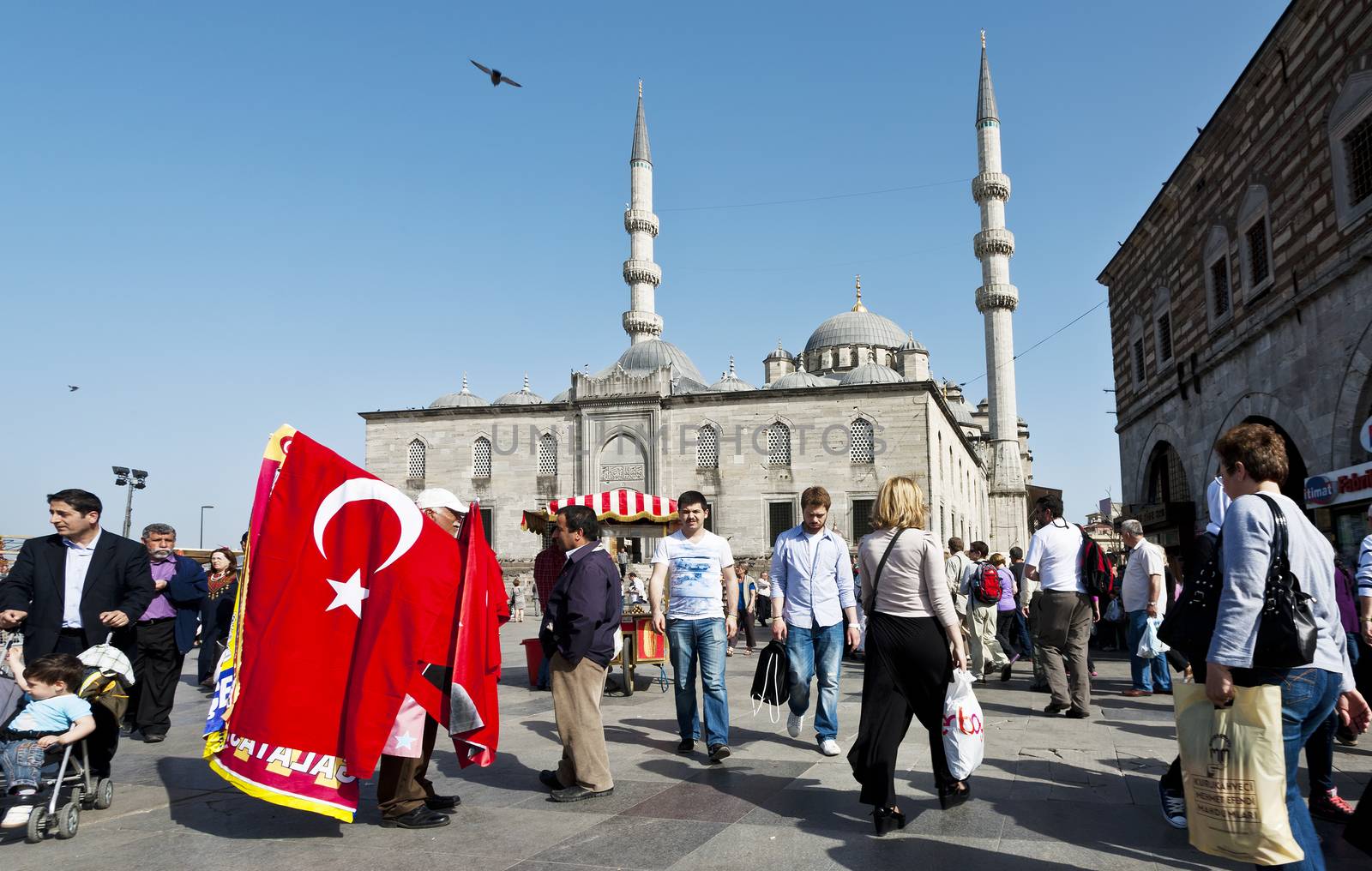 ISTANBUL, TURKEY – APRIL 25: Crowd and unidenified street vendor selling Turkish flags prior to Anzac Day on April 25, 2012 in Istanbul, Turkey. 