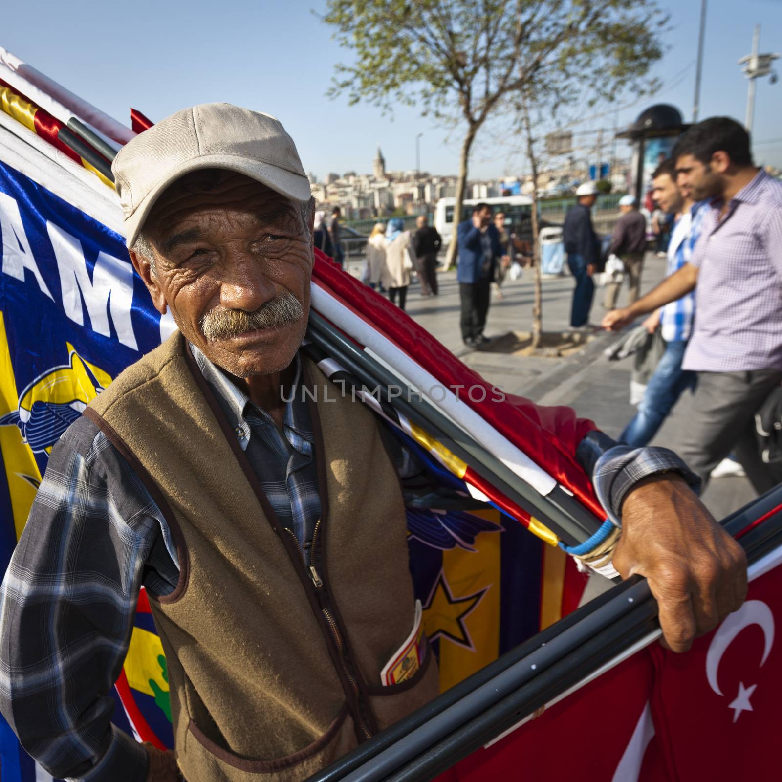 ISTANBUL, TURKEY – APRIL 25: Unidenified street vendor selling Turkish flags near the Istanbul Spice Market prior to Anzac Day on April 25, 2012 in Istanbul, Turkey. 