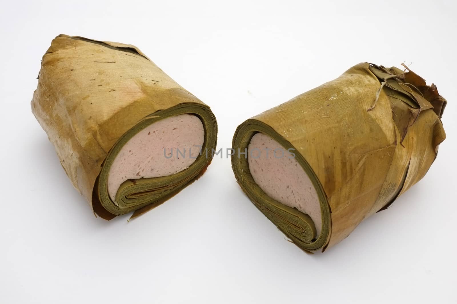 Vietnamese steamed pork sausage wrapped under banana leaf, two half roll by Hepjam