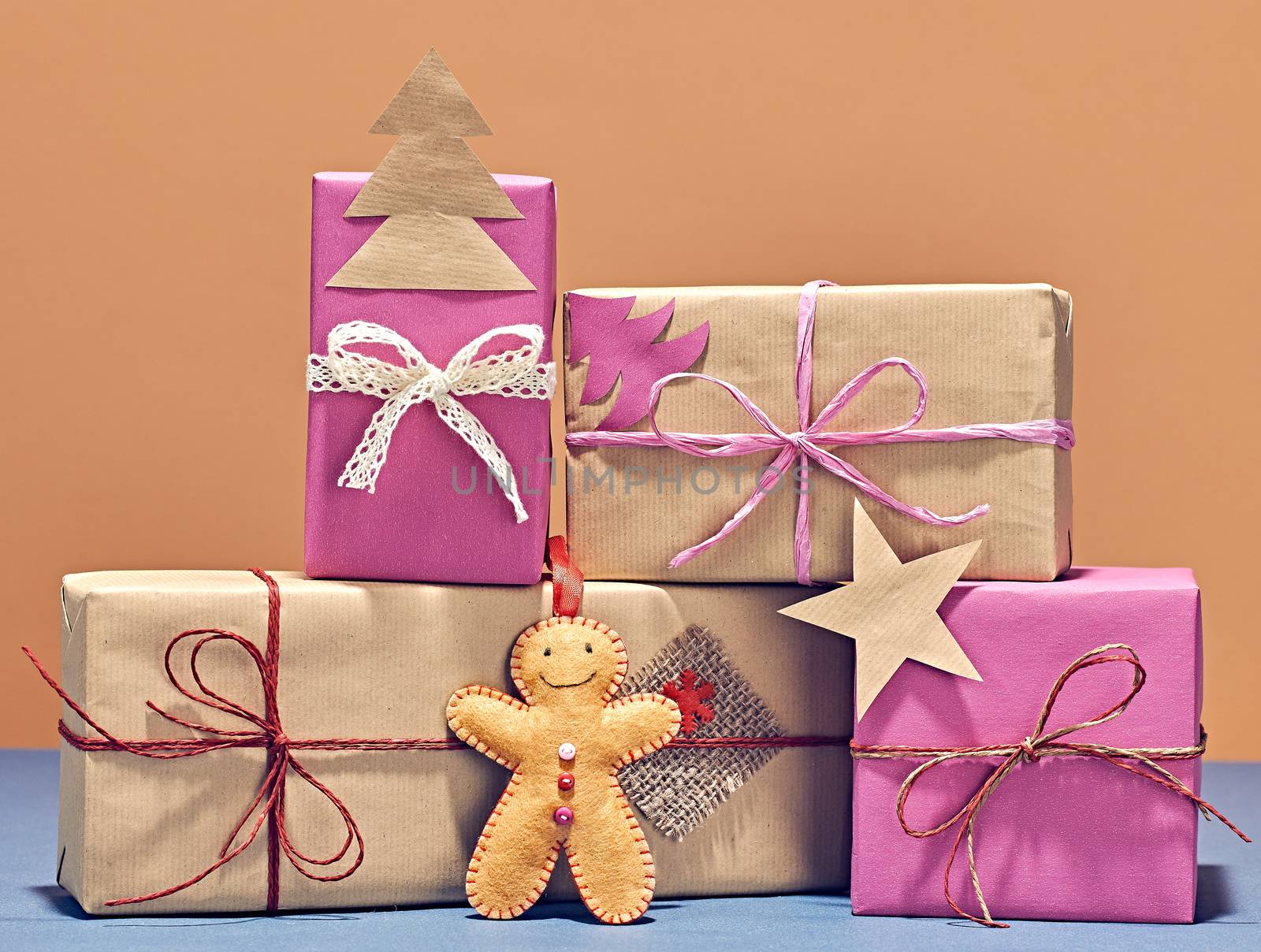 Gift boxes, Merry Christmas. Gingerbread men, kraft paper bows ribbon, lace. Festive creative New Year 2016. Handmade retro vintage, holiday greeting card, party decoration on wood,closeup
