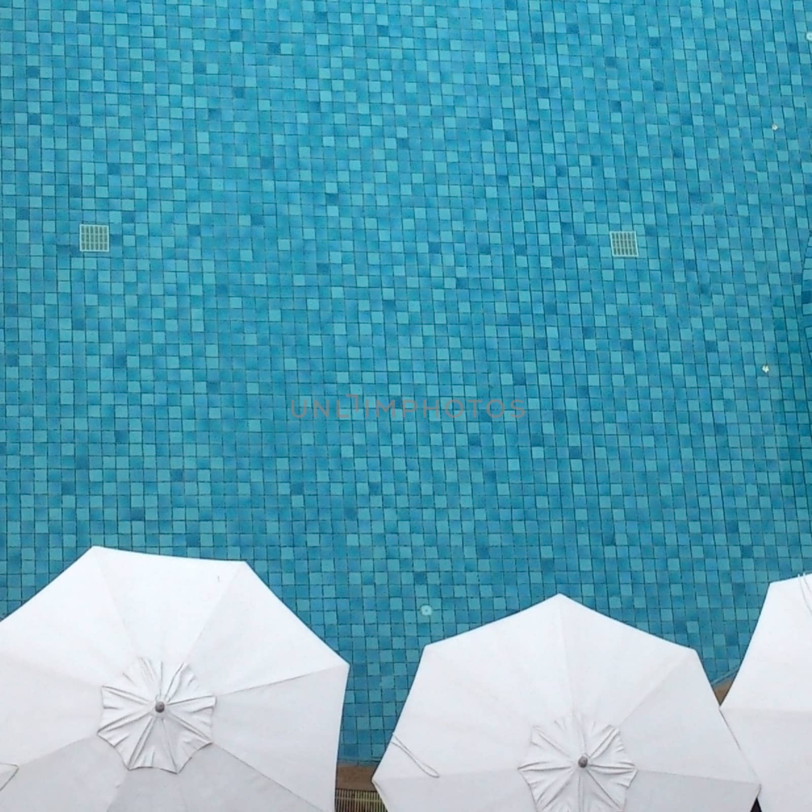 Top view of swimming pool side with umbrella