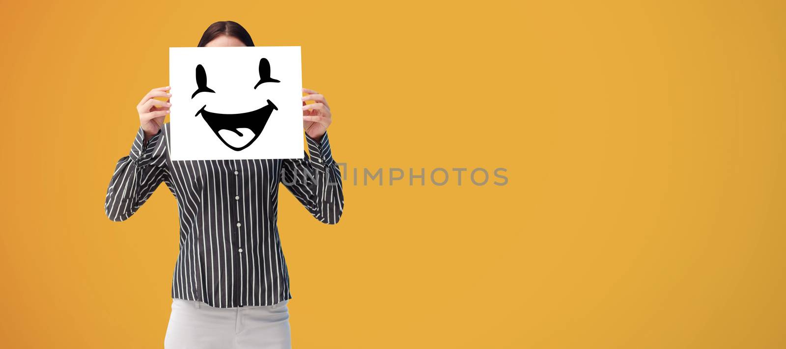 Businesswoman showing a white card in front of her face against yellow