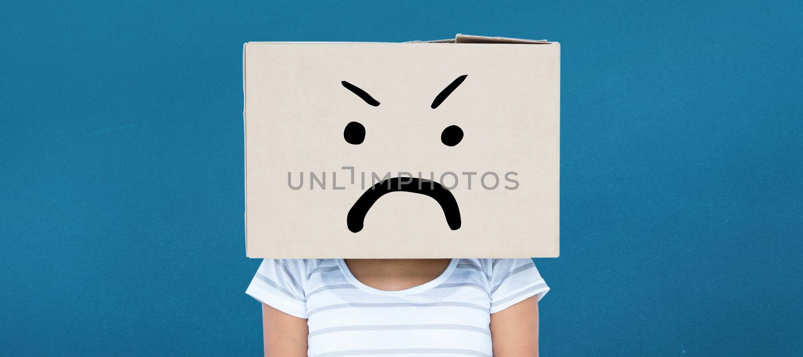 Depressed woman with box over head against blue background