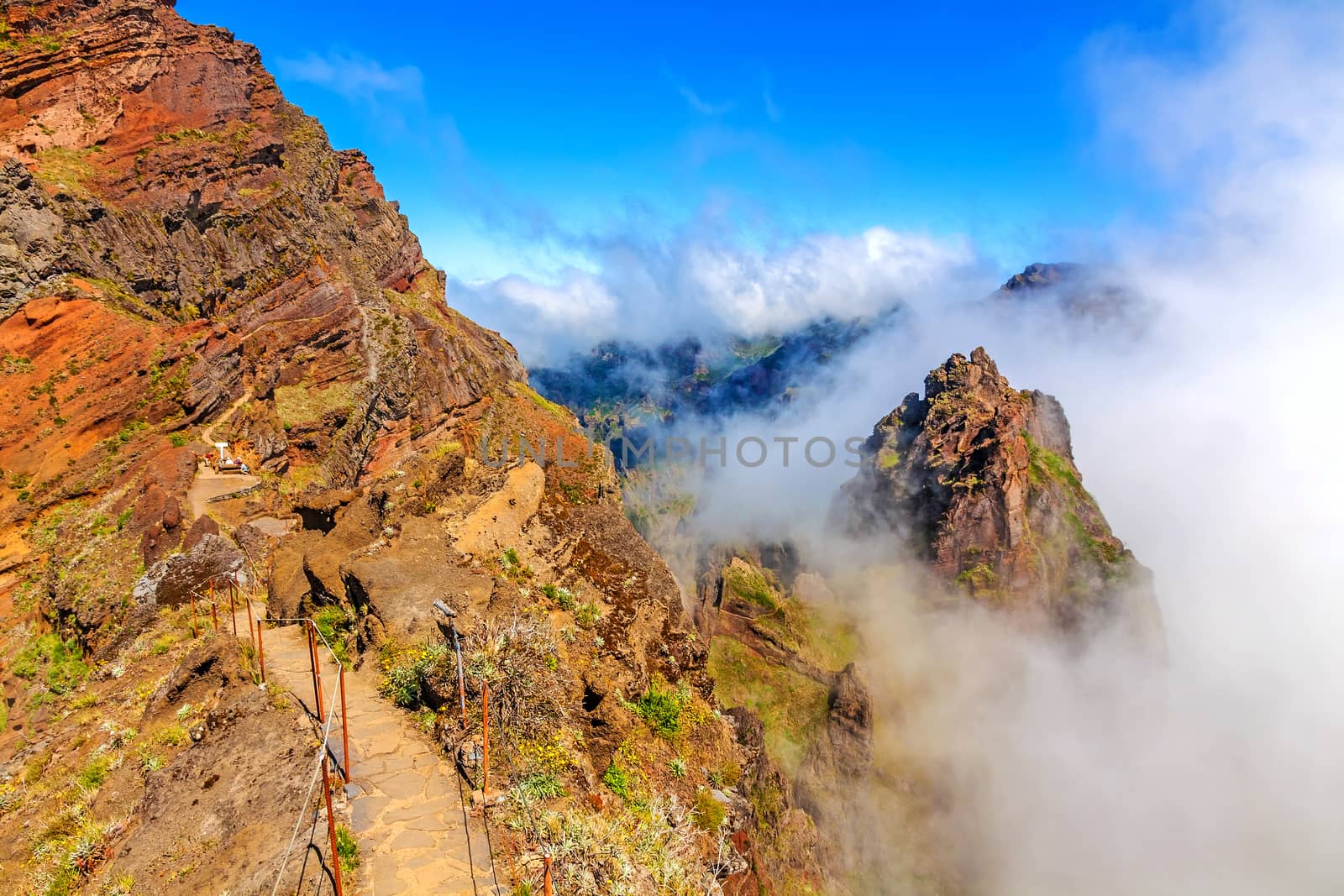 Colorful volcanic mountain landscape with clouds - hiking path from Pico do Arieiro to Pico Ruivo, Madeira, Portugal