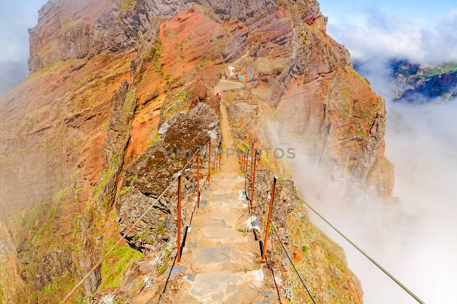 Colorful volcanic mountain landscape with clouds - hiking path from Pico do Arieiro to Pico Ruivo, Madeira, Portugal