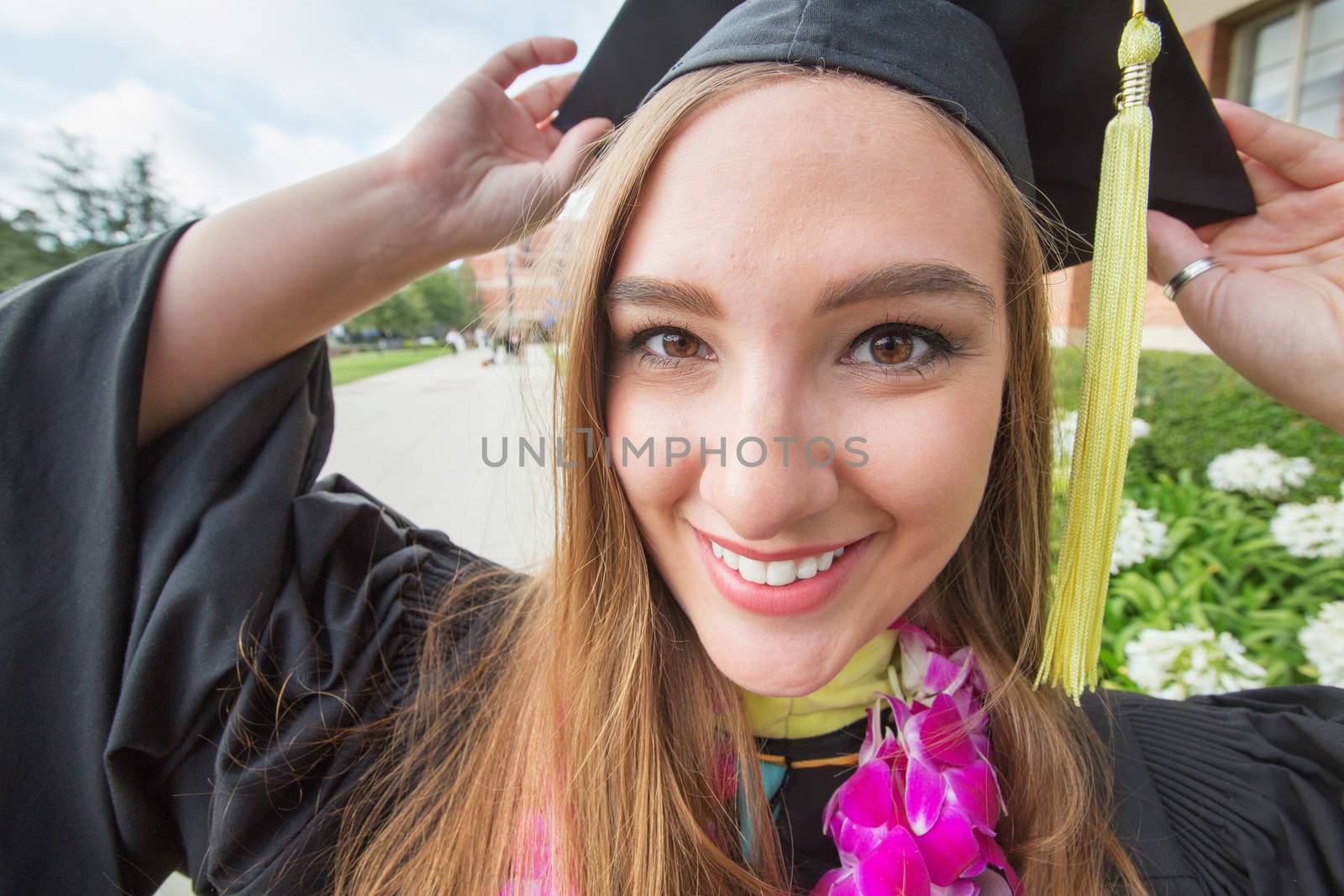 Energetic Caucasian female college student with cap outdoors