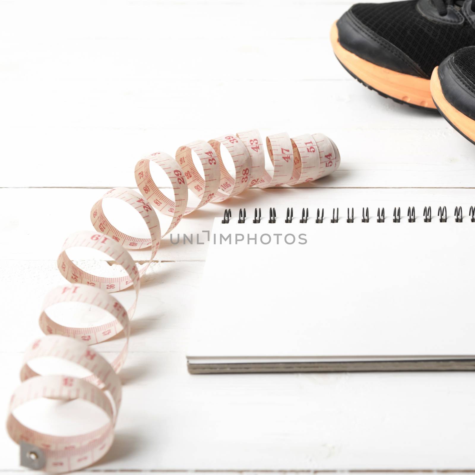 running shoes with notebook and measuring tape by ammza12