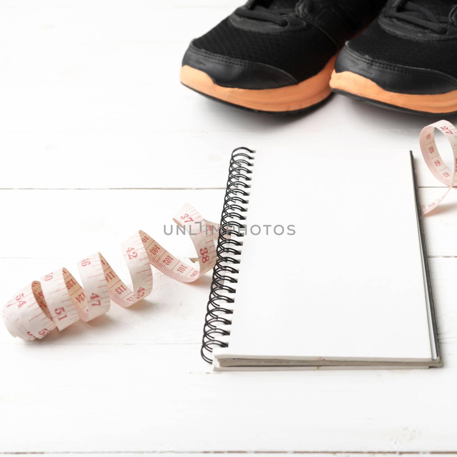 running shoes with notebook and measuring tape by ammza12