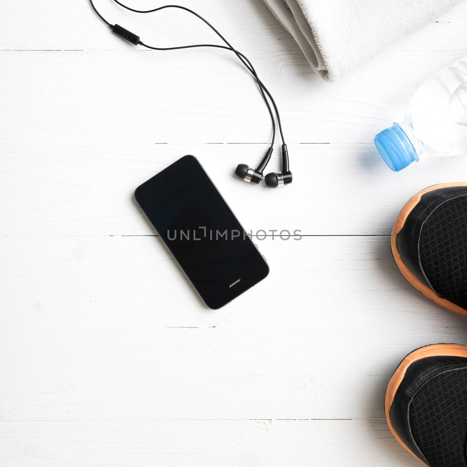 fitness equipment:running shoes,water bottle,towel,smart phone