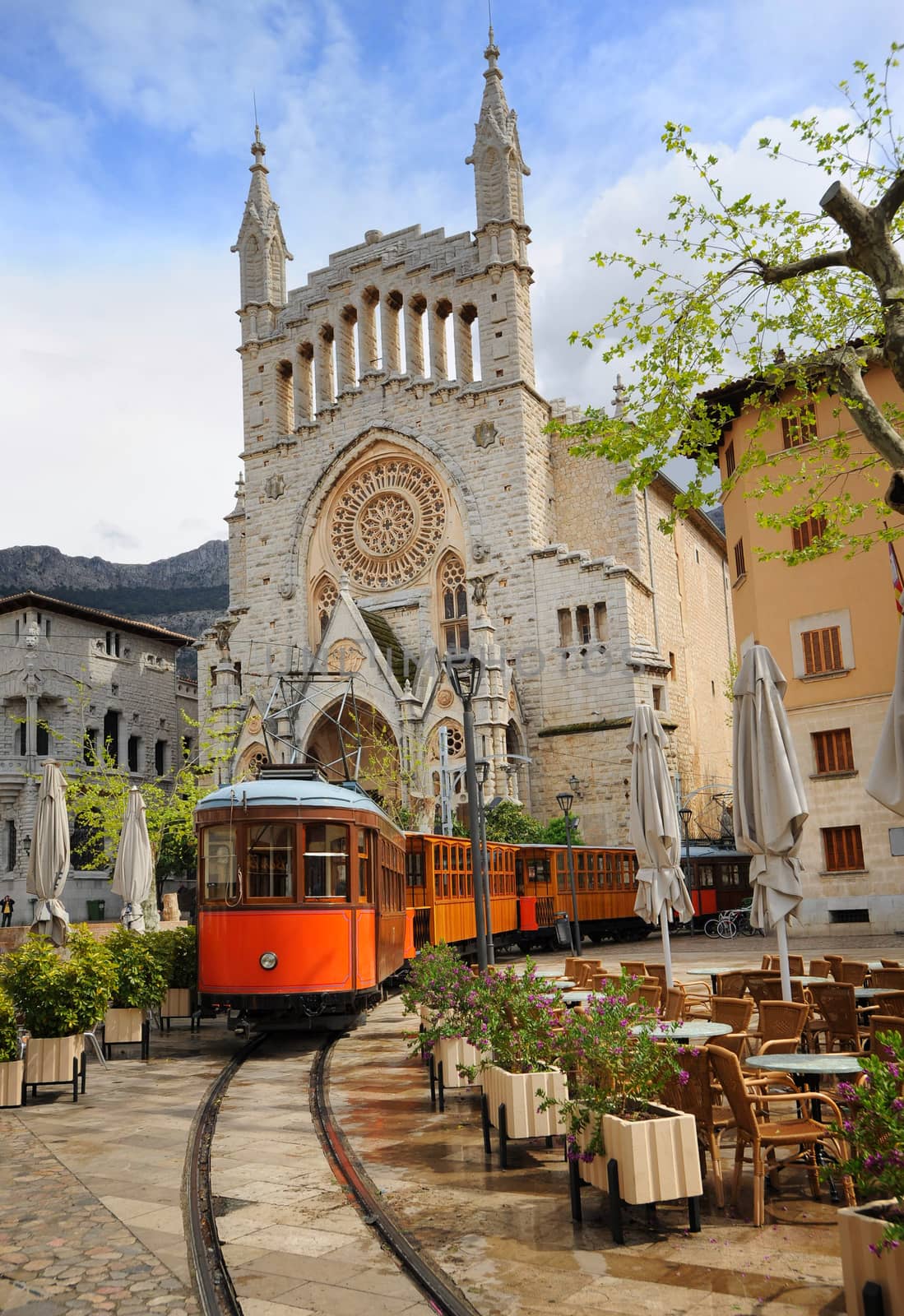 Old tram in front of the Cathedral of Soller, Mallorca, Spain by GlobePhotos