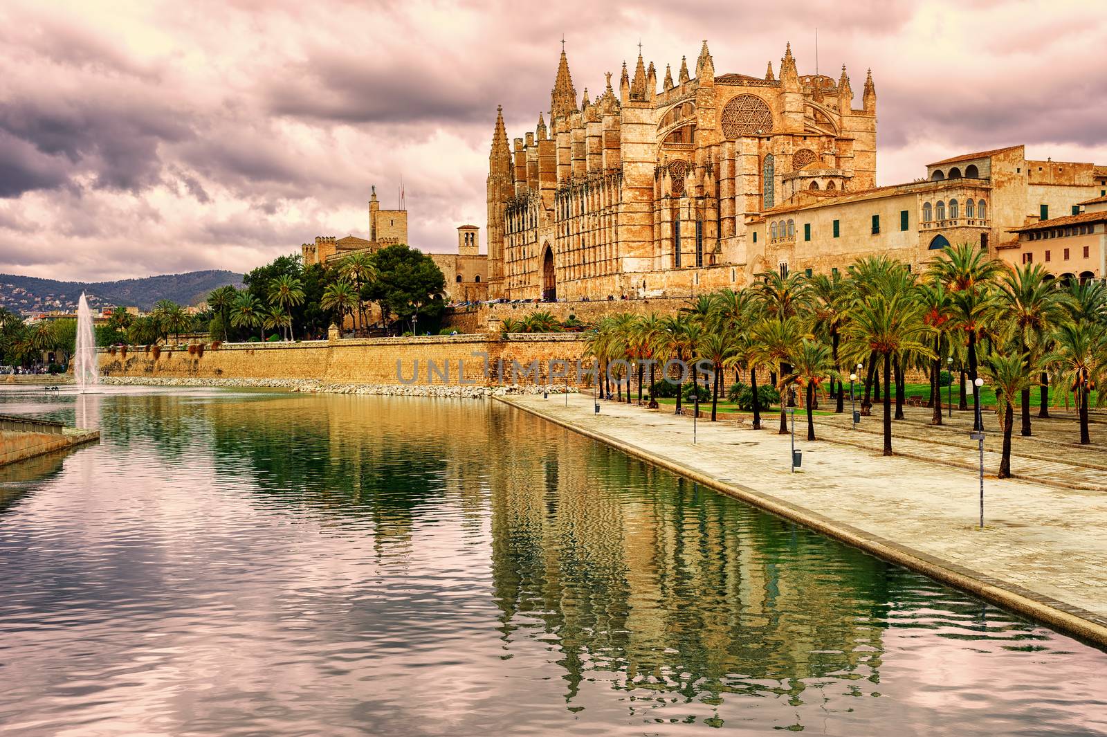La Seu, the cathedral of Palma de Mallorca, reflecting in the water on sunset, Spain