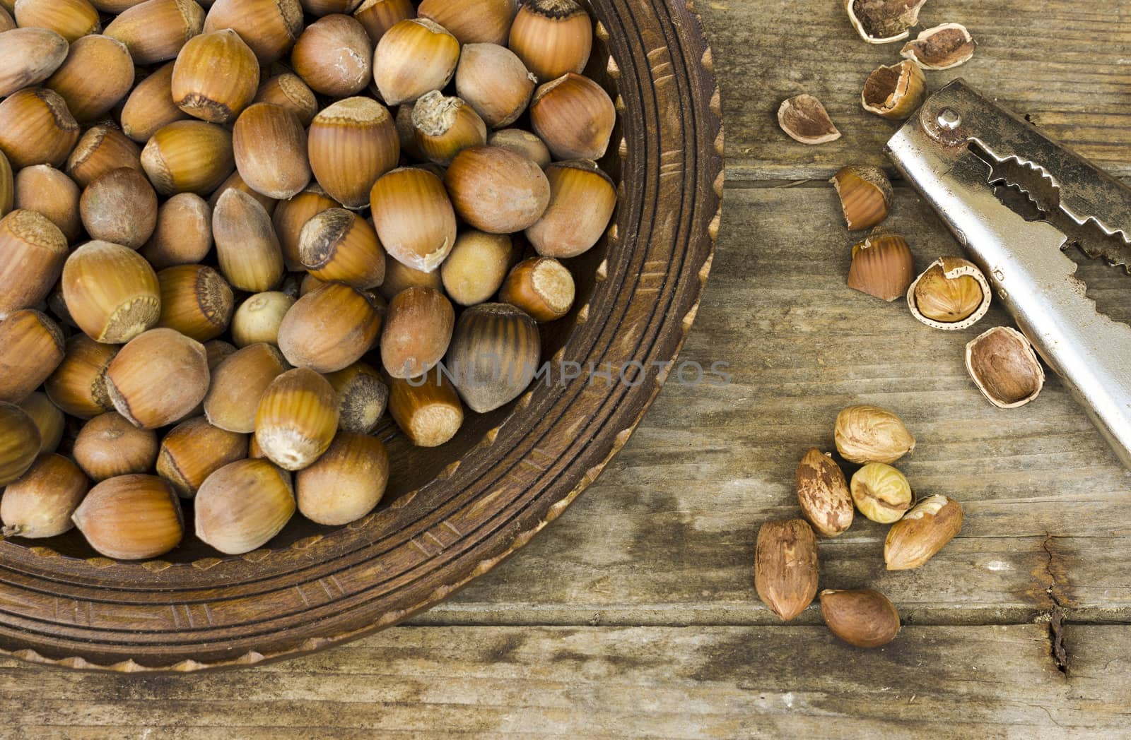 Hazelnut in a wooden bowl on rustic background