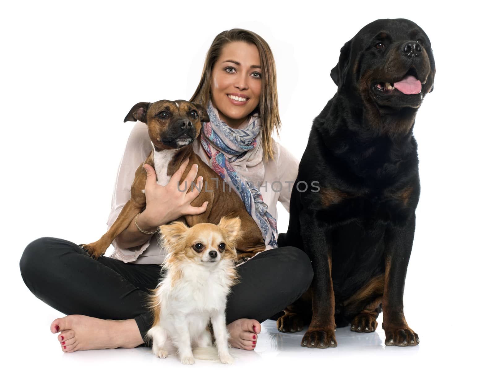 woman and dogS in front of white background