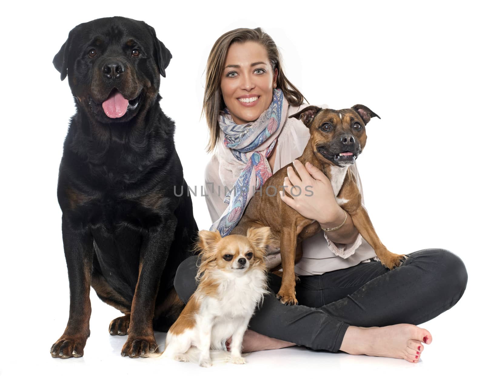 woman and dogS in front of white background