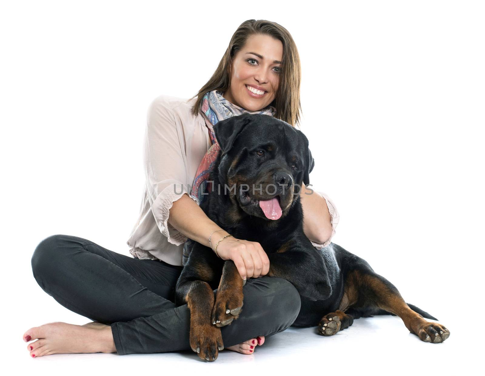 woman and rottweiler in front of white background