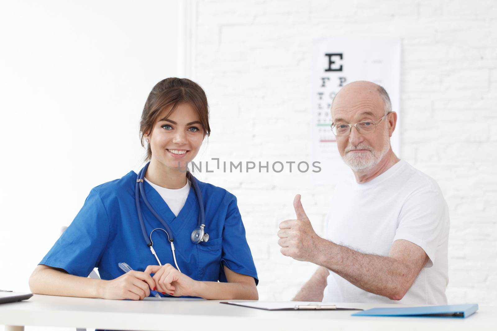 Happy senior patient with new glasses in ophthalmologist office