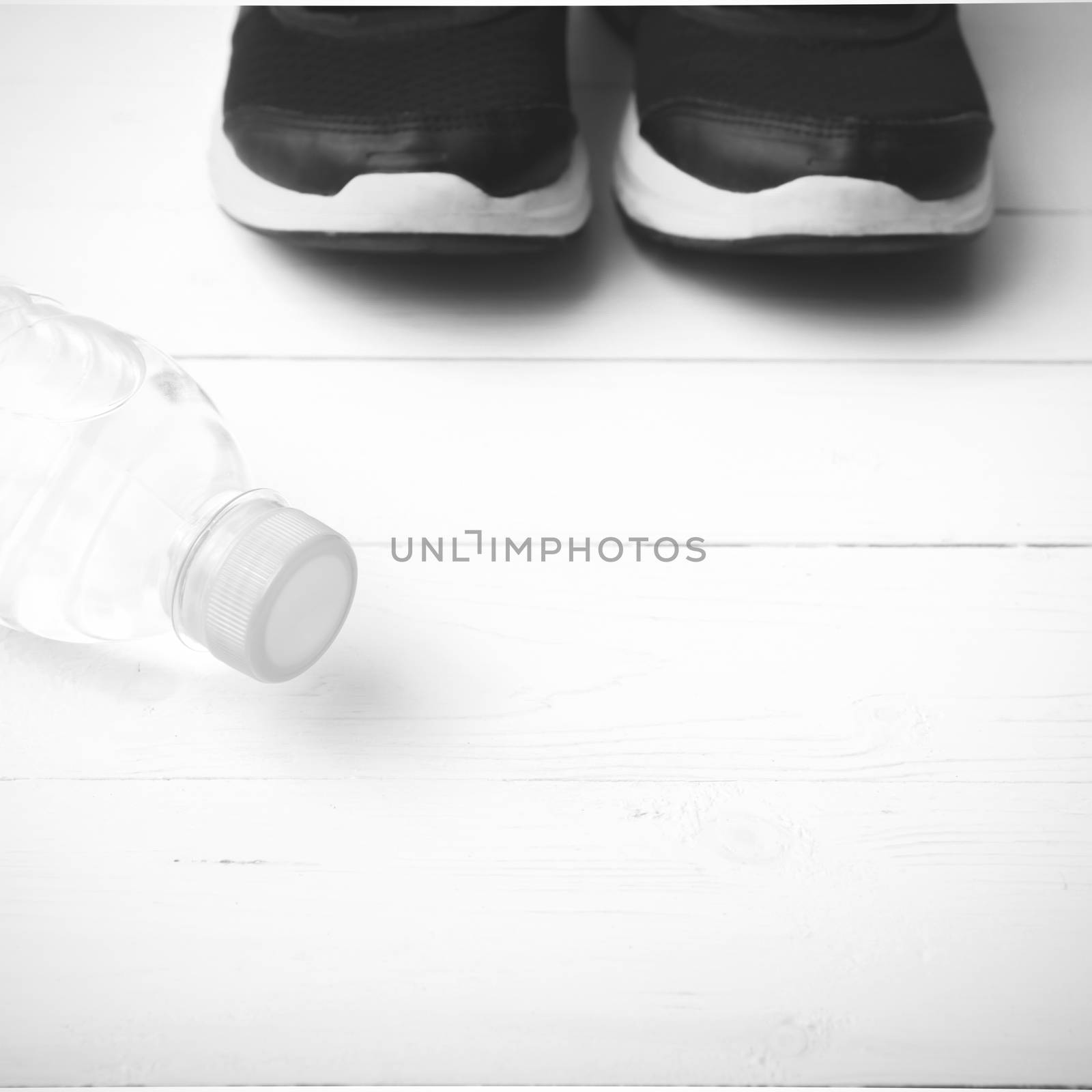 running shoes and drinking water on white table black and white tone color style