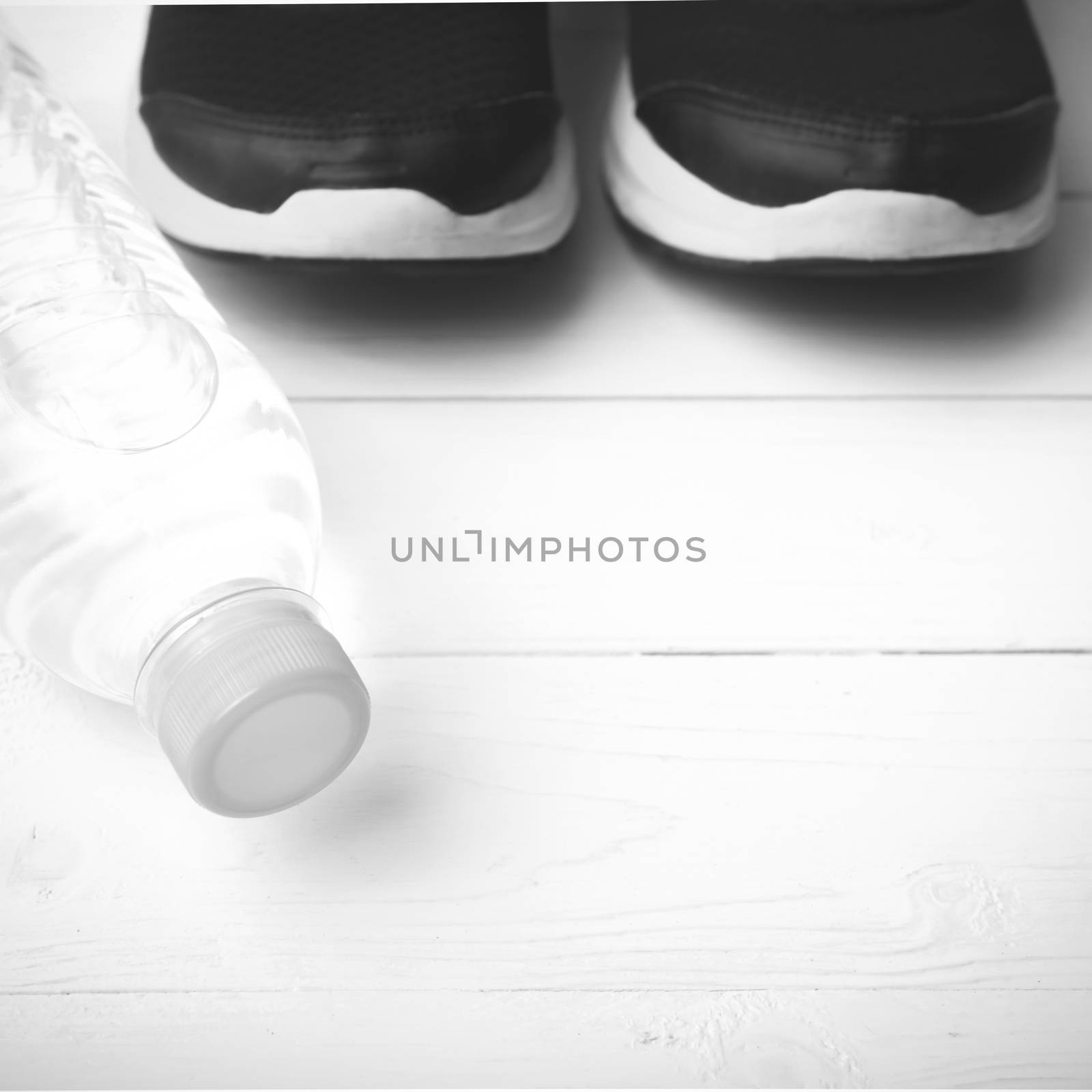 running shoes and drinking water on white table black and white tone color style