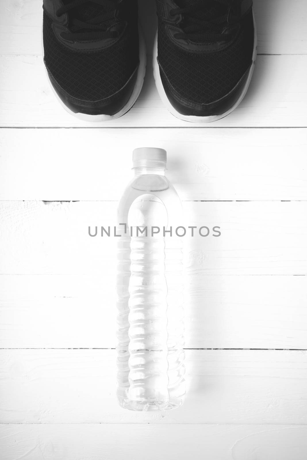 running shoes and drinking water on white table black and white tone color style