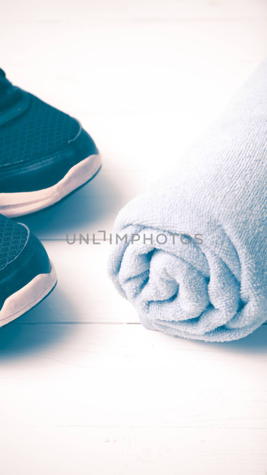running shoes and towel on white wood table vintage style