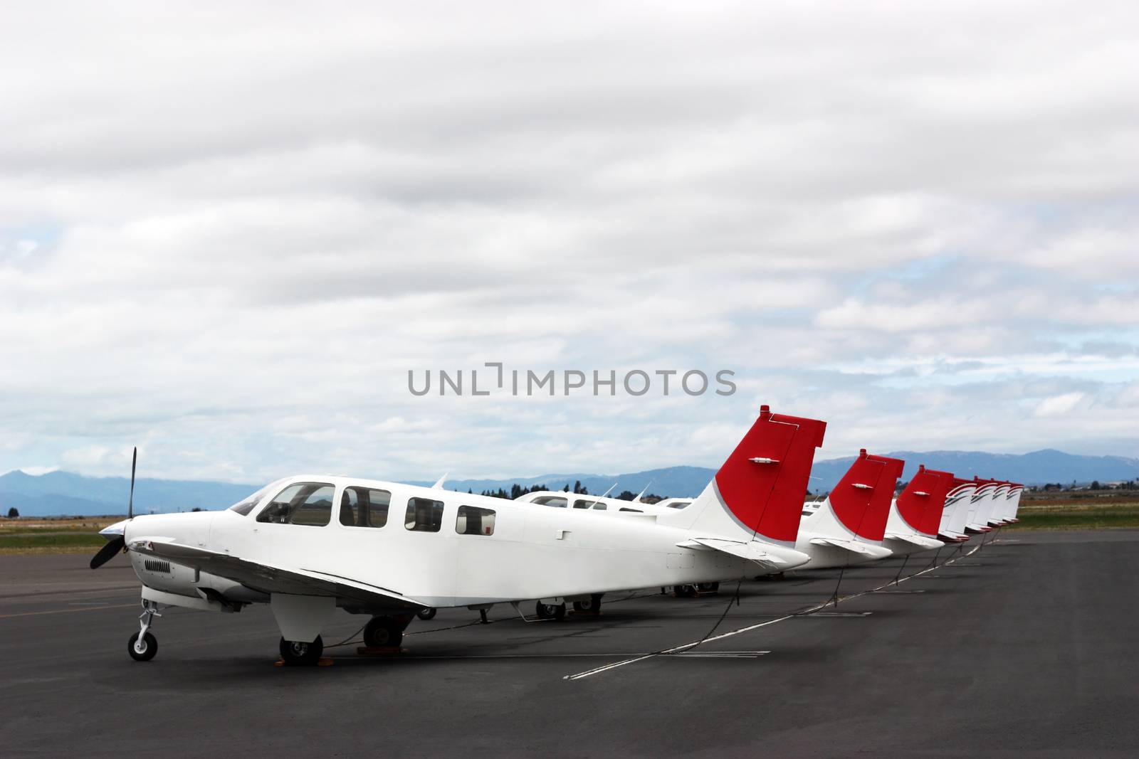 Airplanes standing in row on private parking 