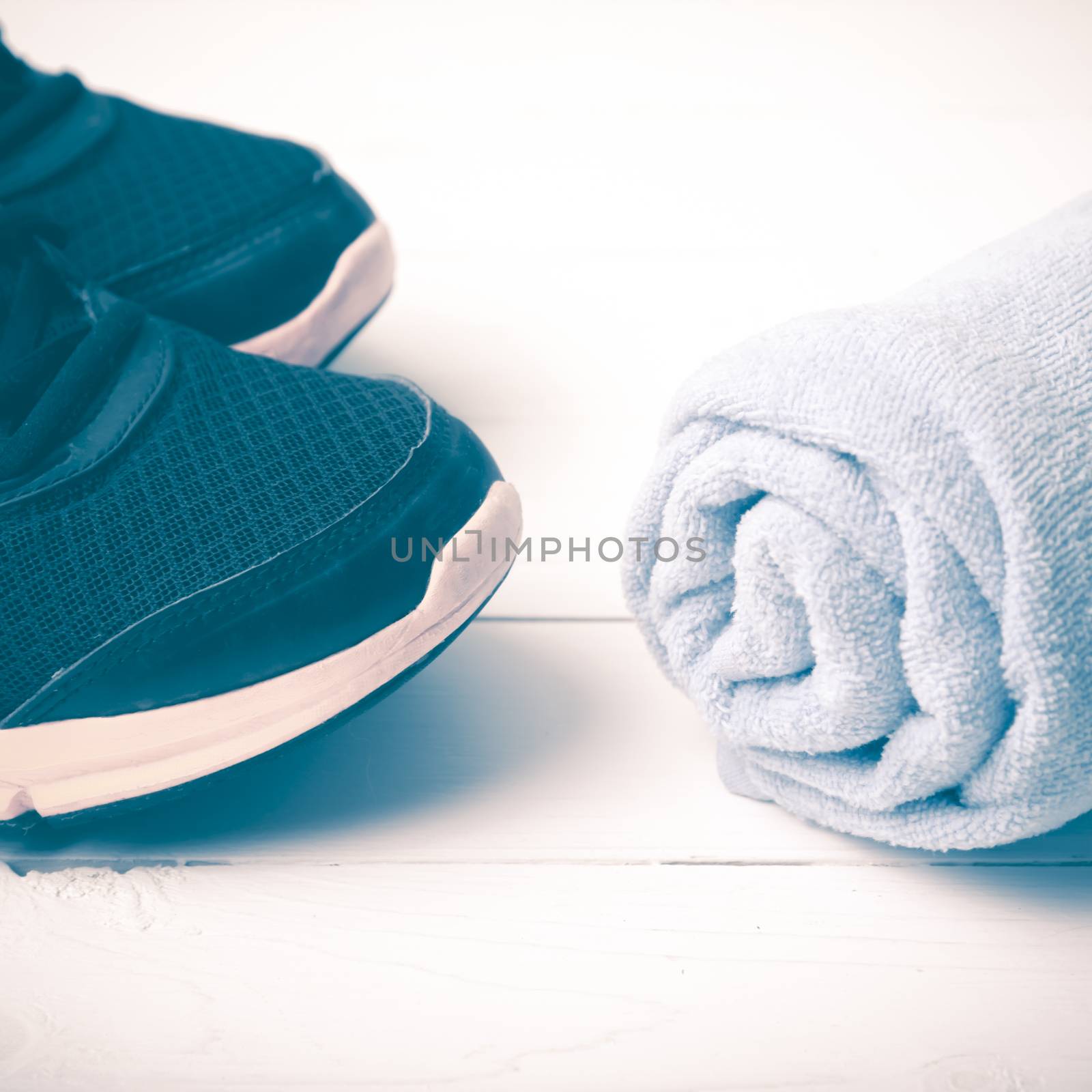 running shoes and towel on white wood table vintage style