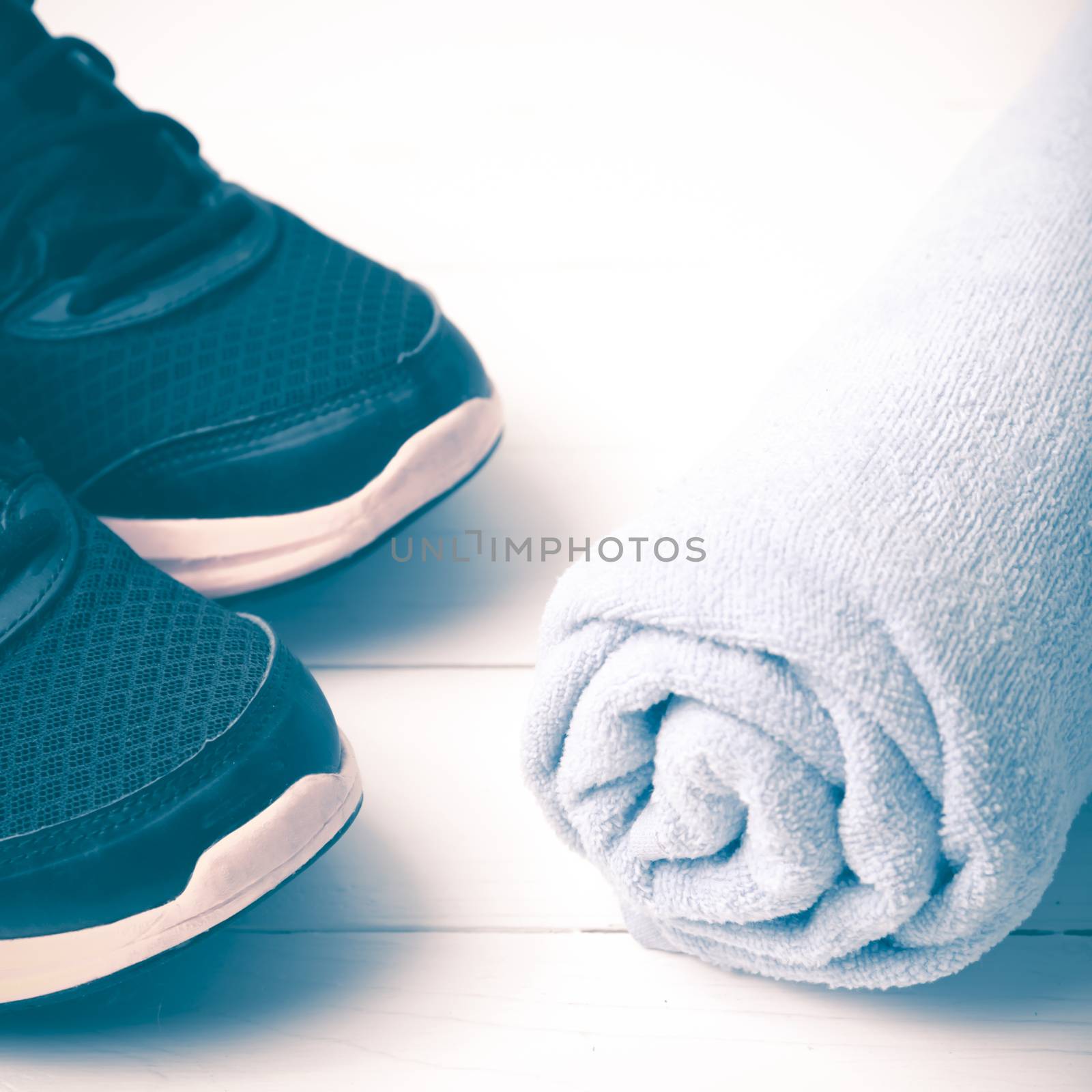 running shoes and towel on white wood table vintage style