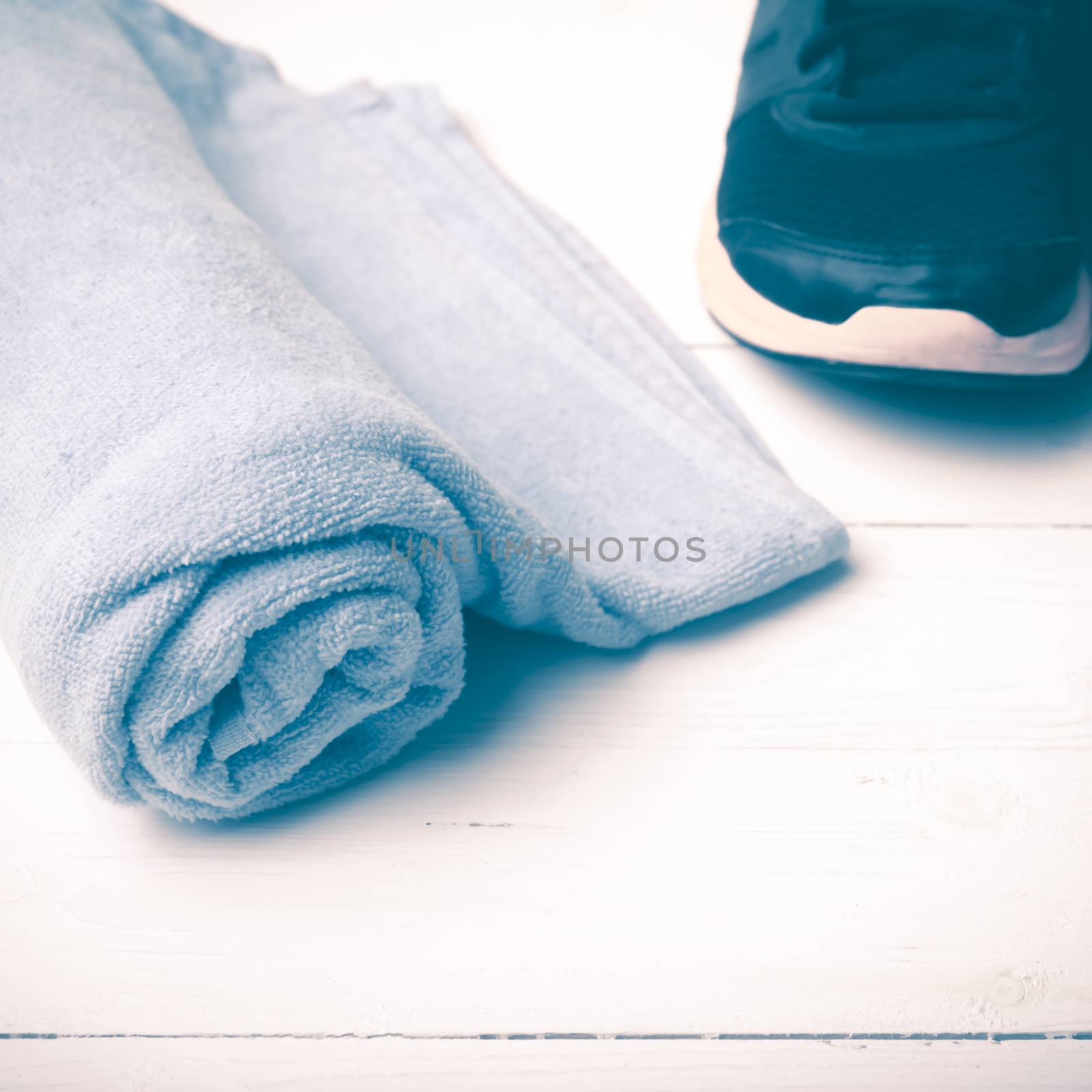 running shoes and towel on white wood table vintage style