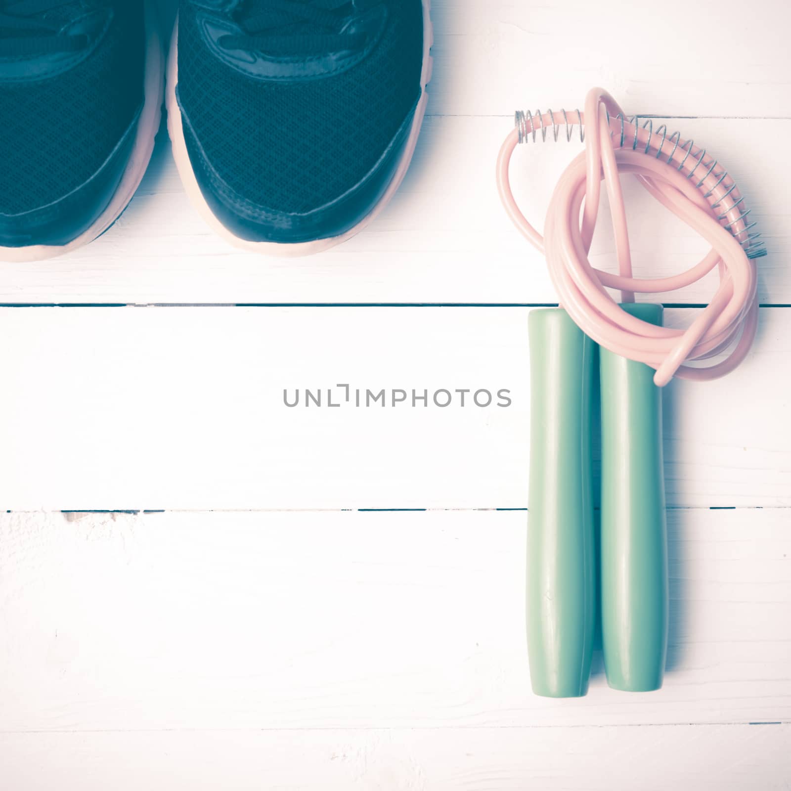 running shoes and jumping rope on white table vintage style