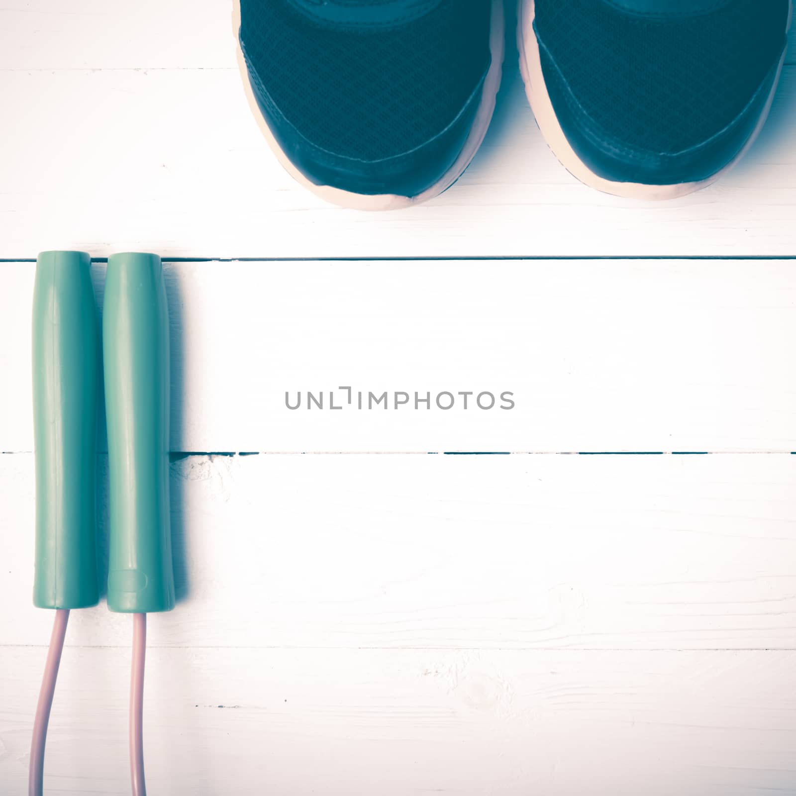 running shoes and jumping rope on white table vintage style