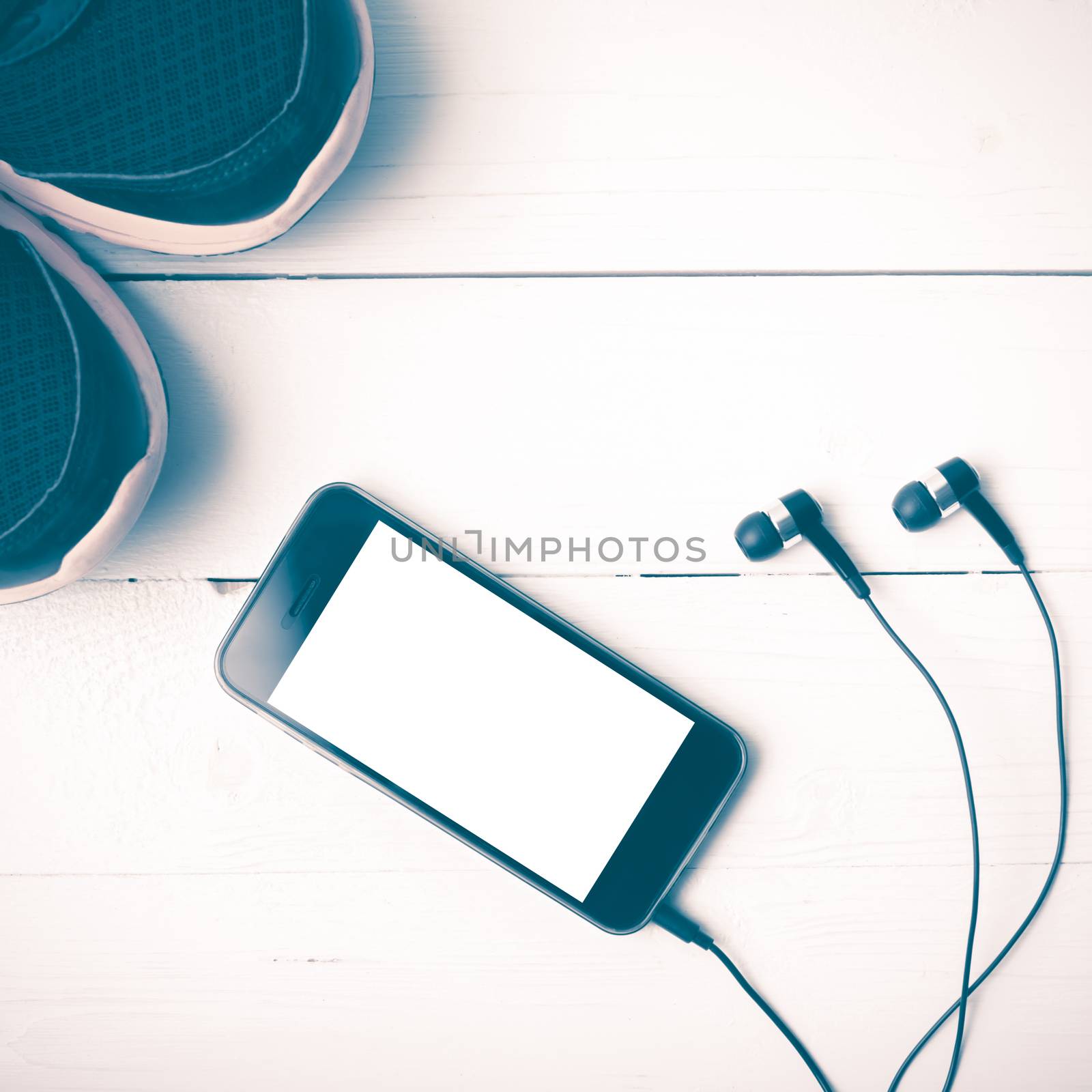 running shoes and phone on white wood table vintage style