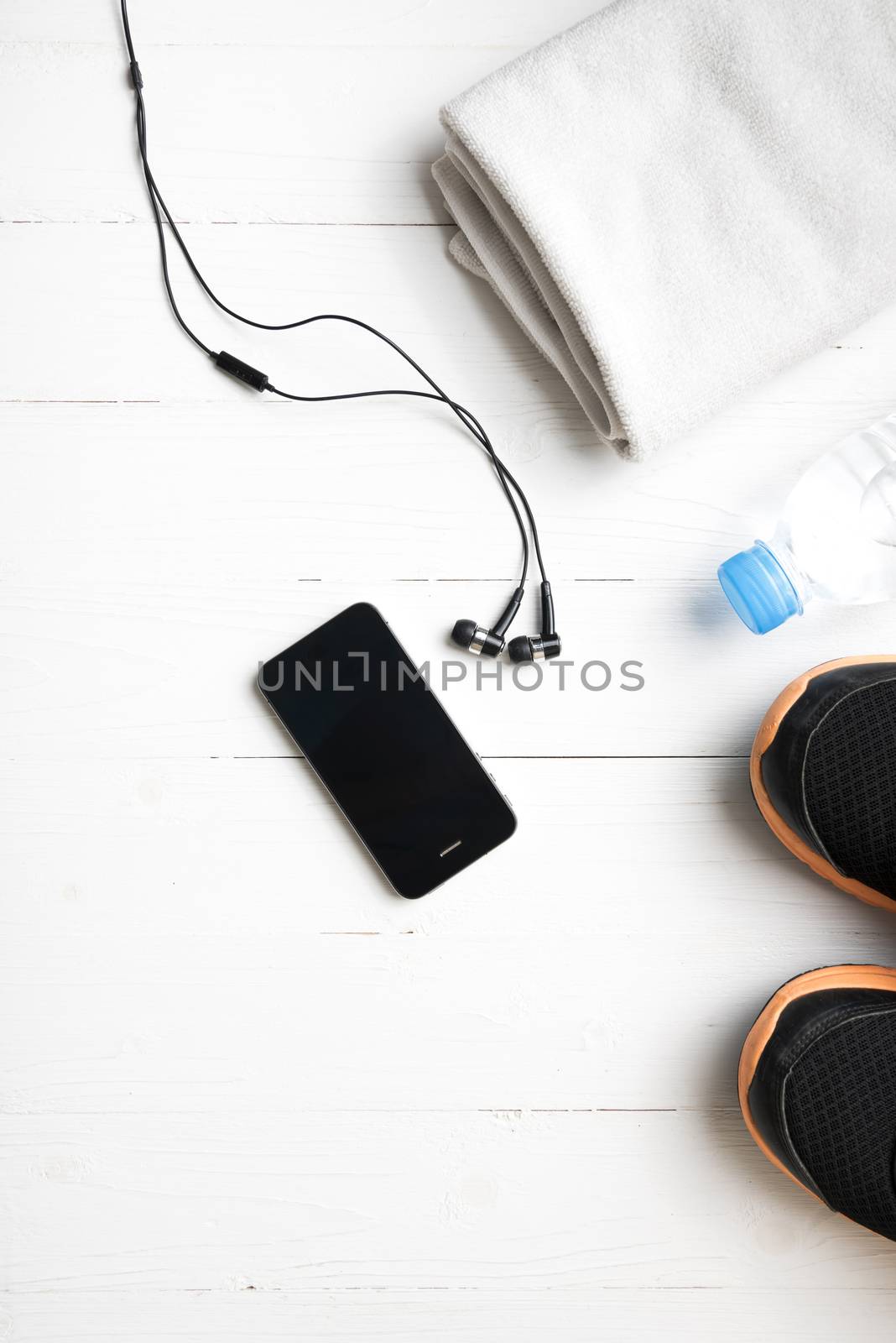 fitness equipment:running shoes,water bottle,towel,smart phone