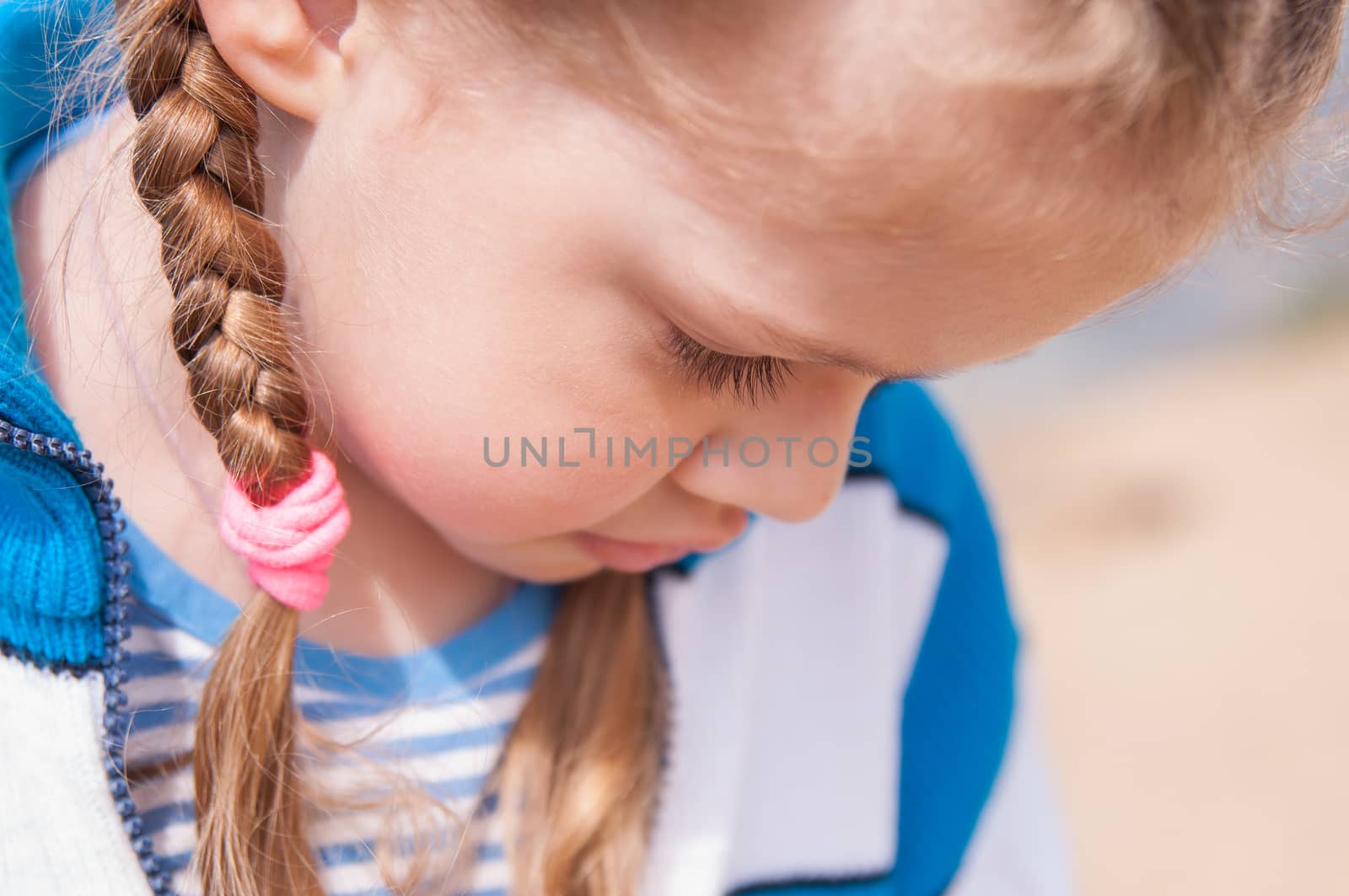 Upset girl turns away and hides her face looking down
