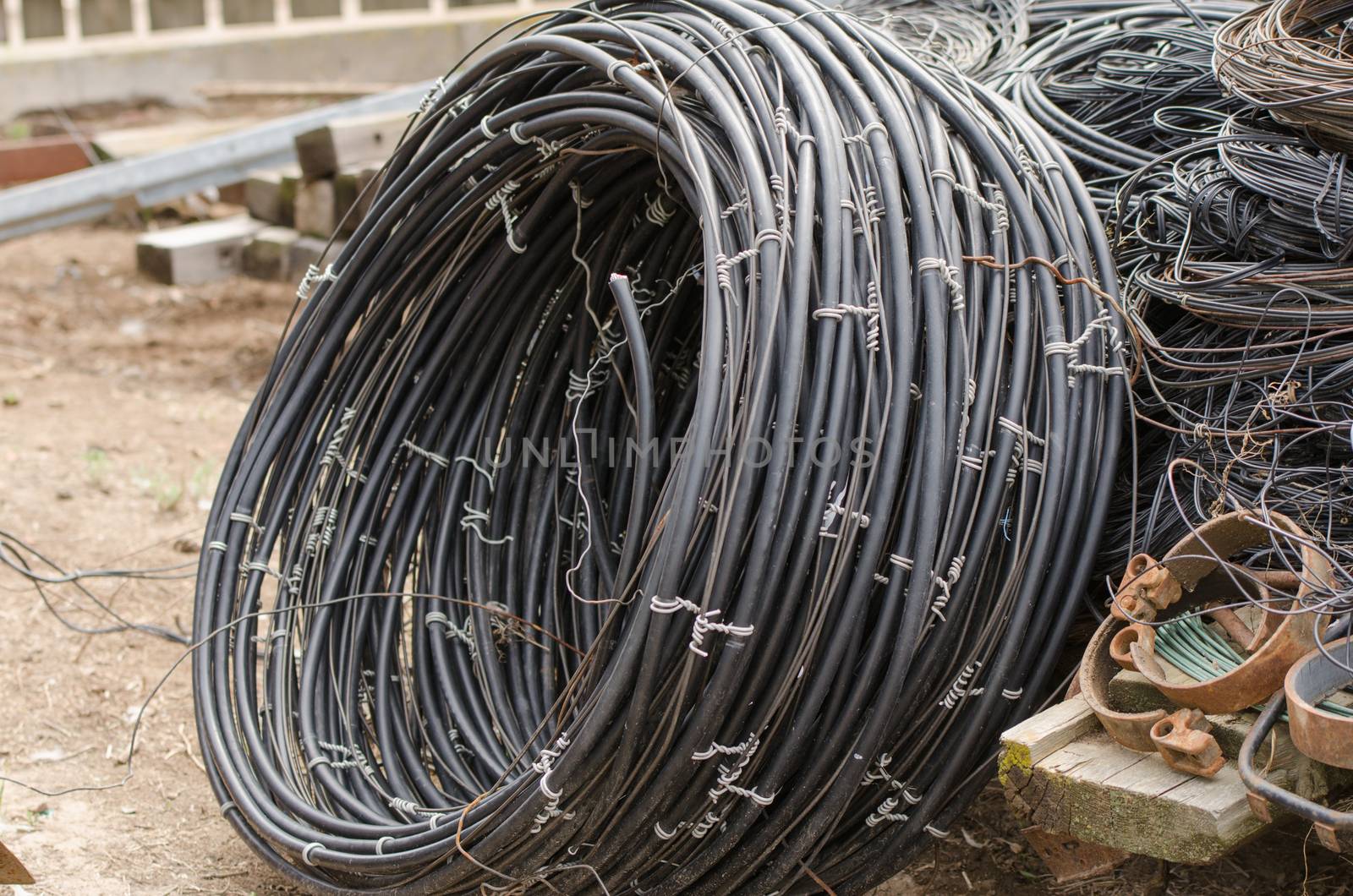 pile of old electrical high-voltage wires lying on the ground