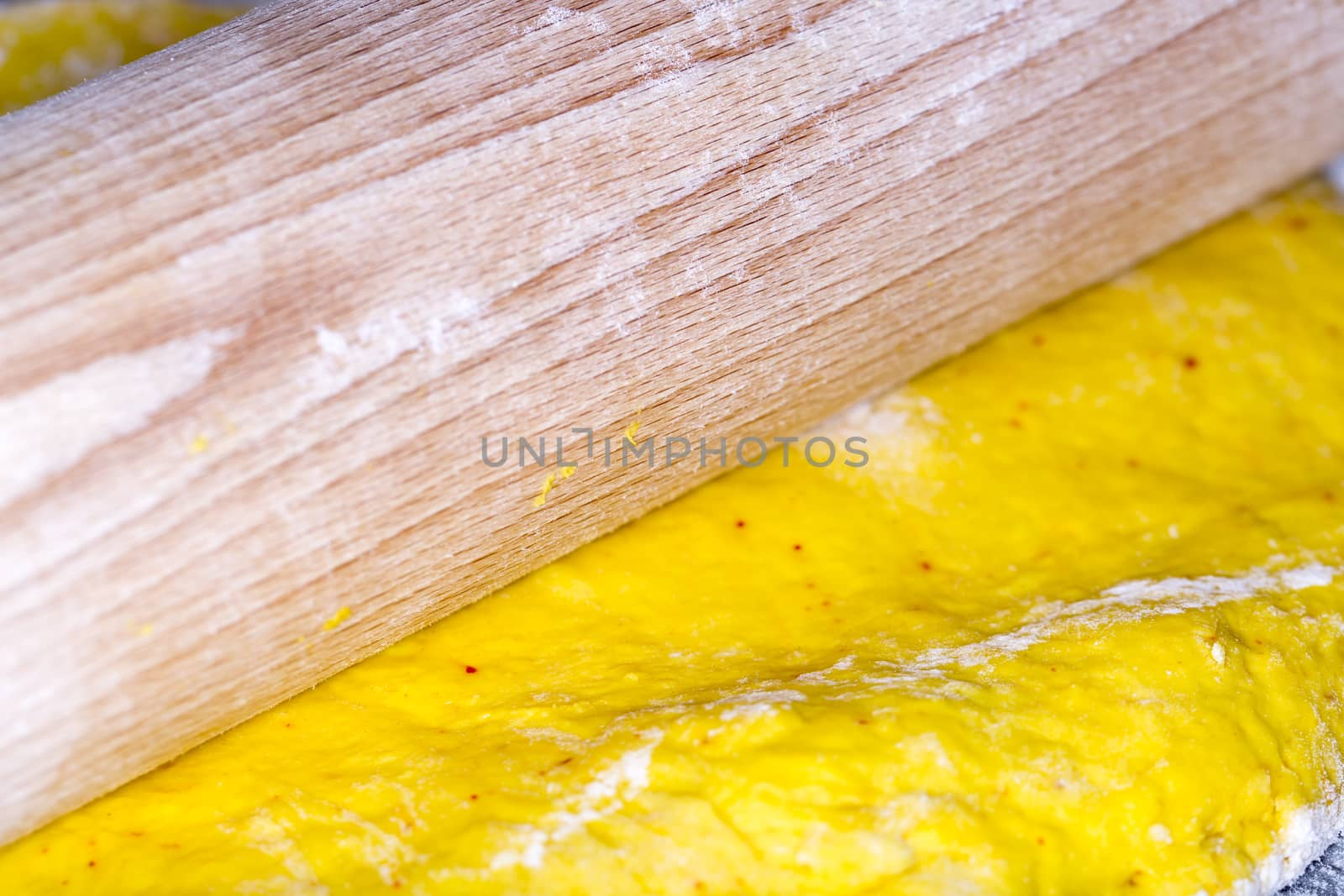 Saffron Bun Dough with Roller close up macro image.