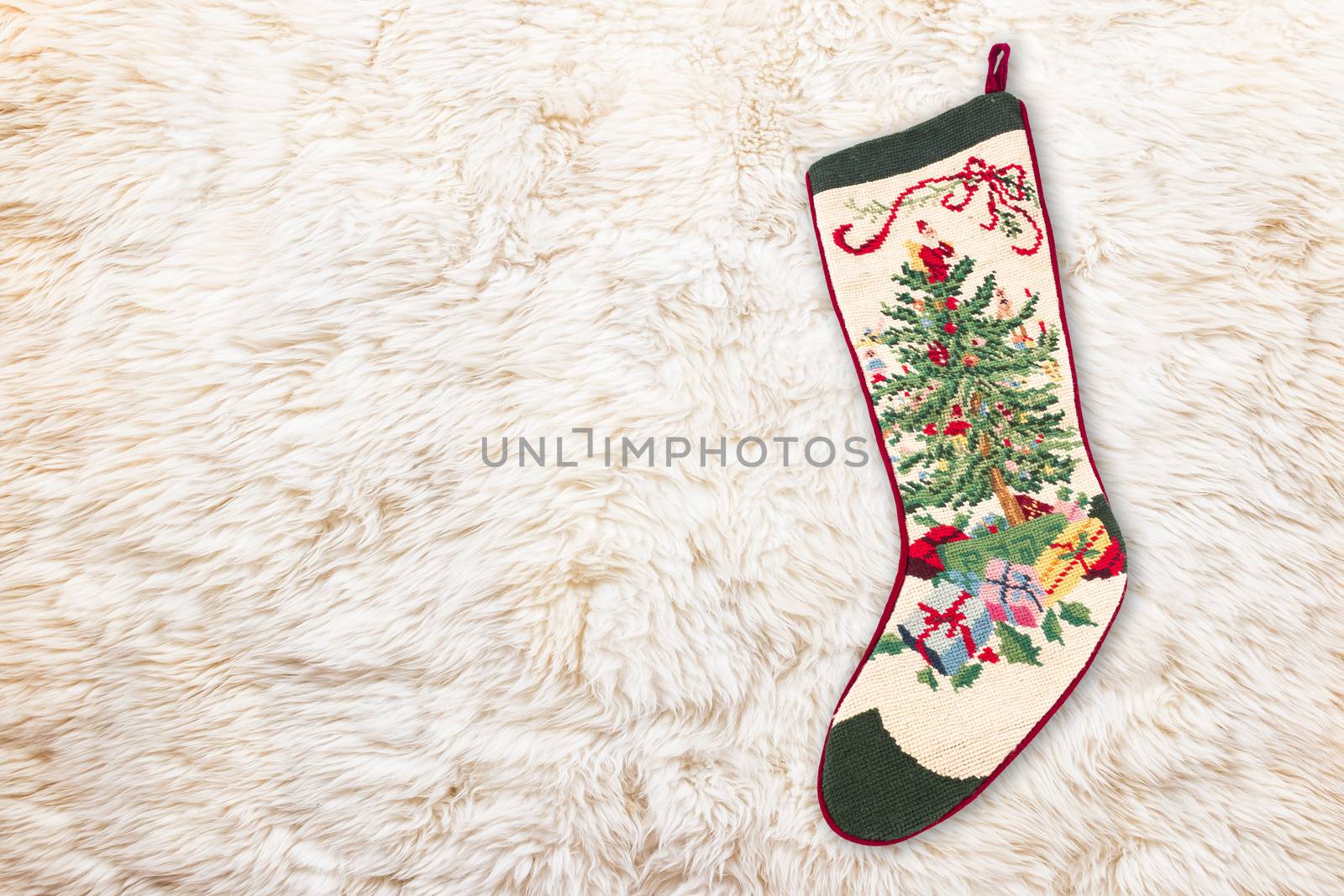 Christmas cross stitch stocking on white fur , use for background